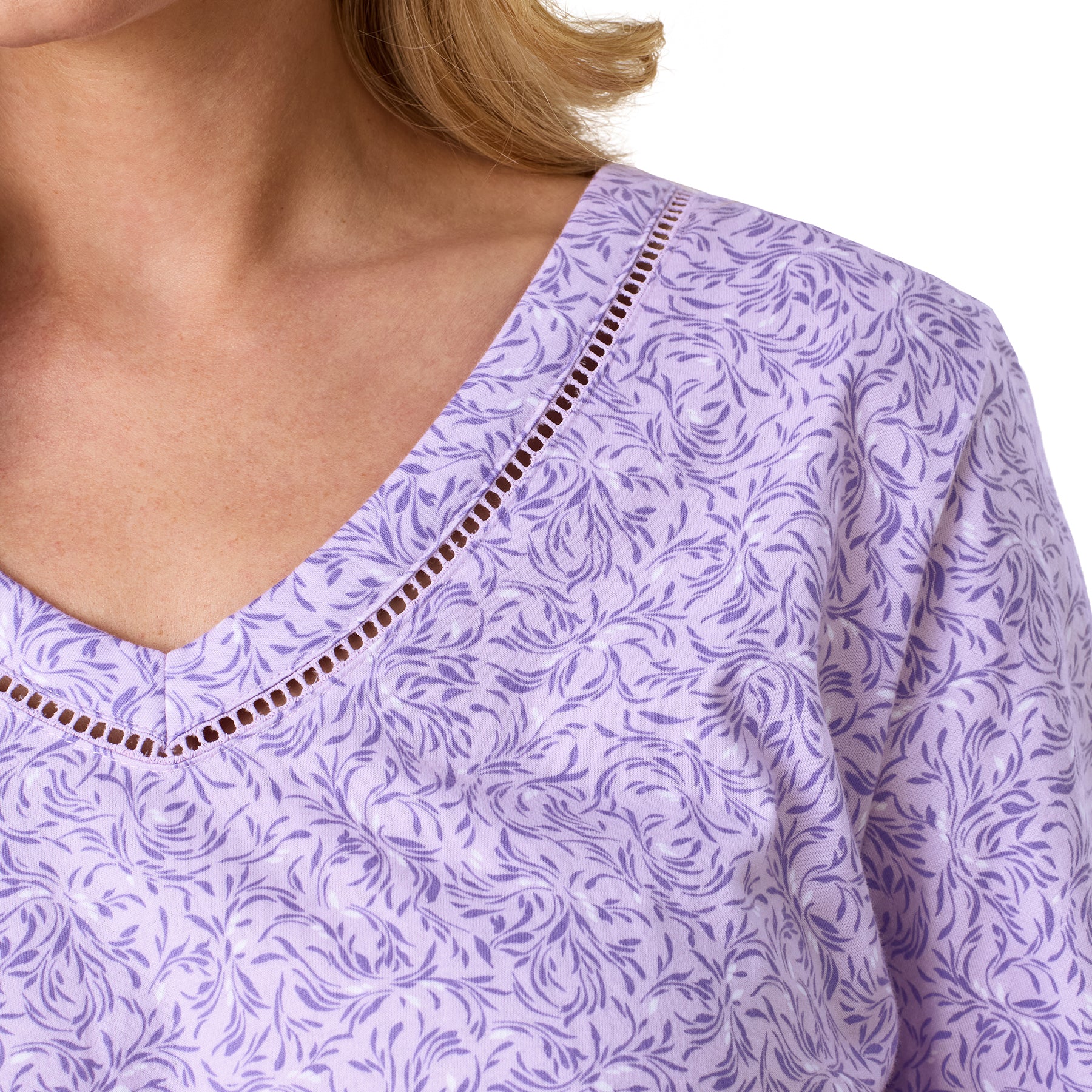 Close-up of the Carole Hochman lavender long sleeve pajama top featuring a soft floral print, V-neckline, and decorative ladder trim.