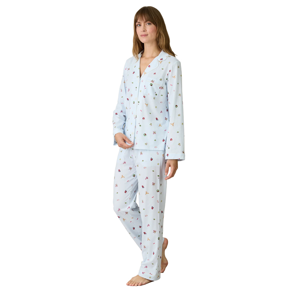 Carole Hochman women's light blue Christmas pajamas with a relaxed-fit button-front top, long sleeves, notched collar and matching pants decorated with colourful holiday motifs.