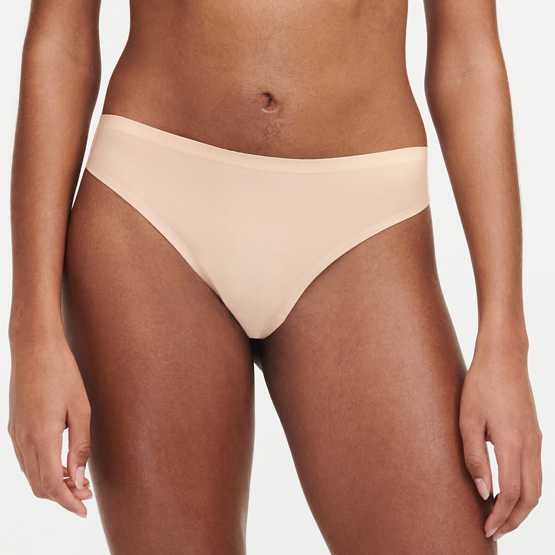 Chantelle Soft Stretch thong in golden beige - seamless high-cut invisible underwear. Front view on model.