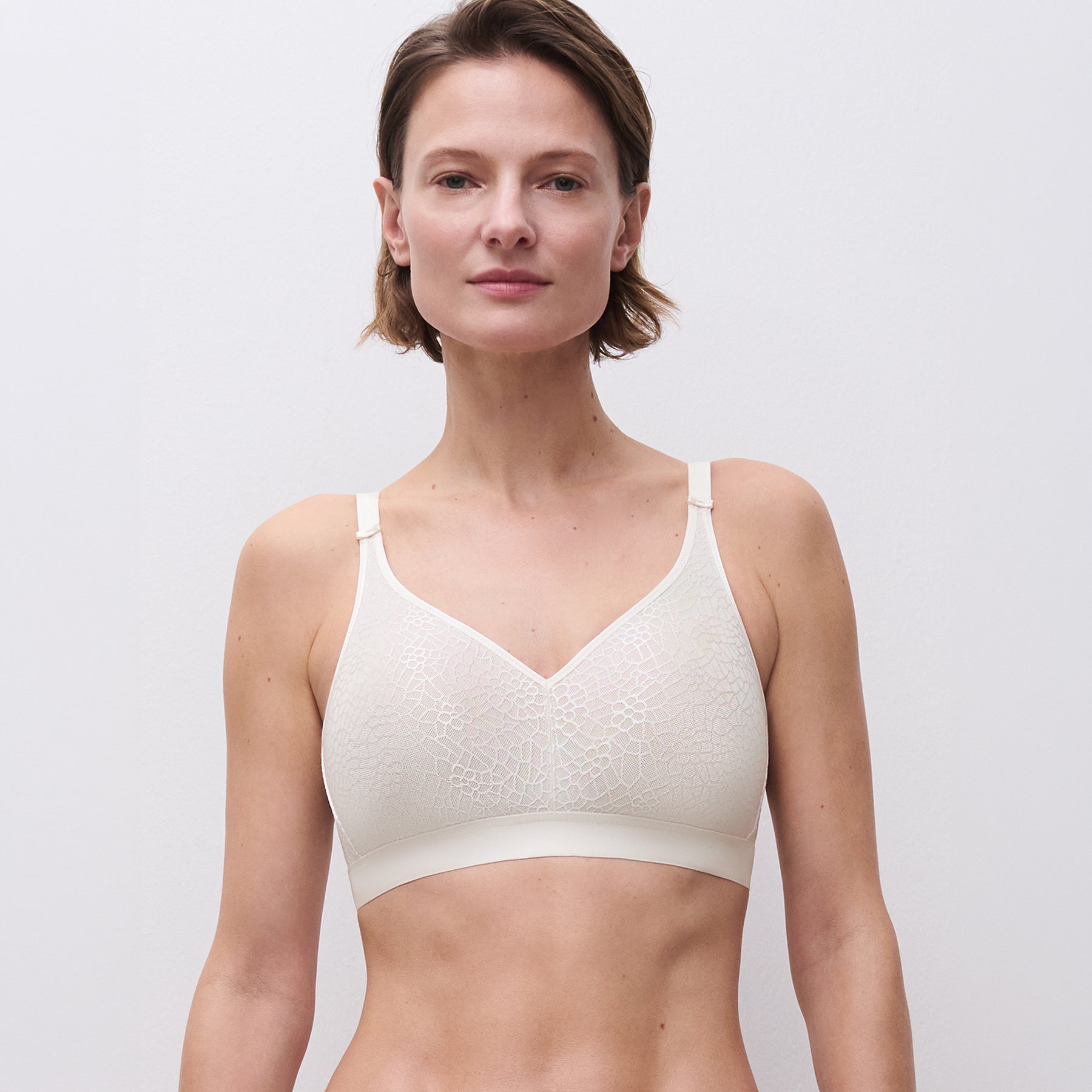 Chantelle C1892 C Magnifique seamless minimizing wireless bra in ivory 035. Front view on model.