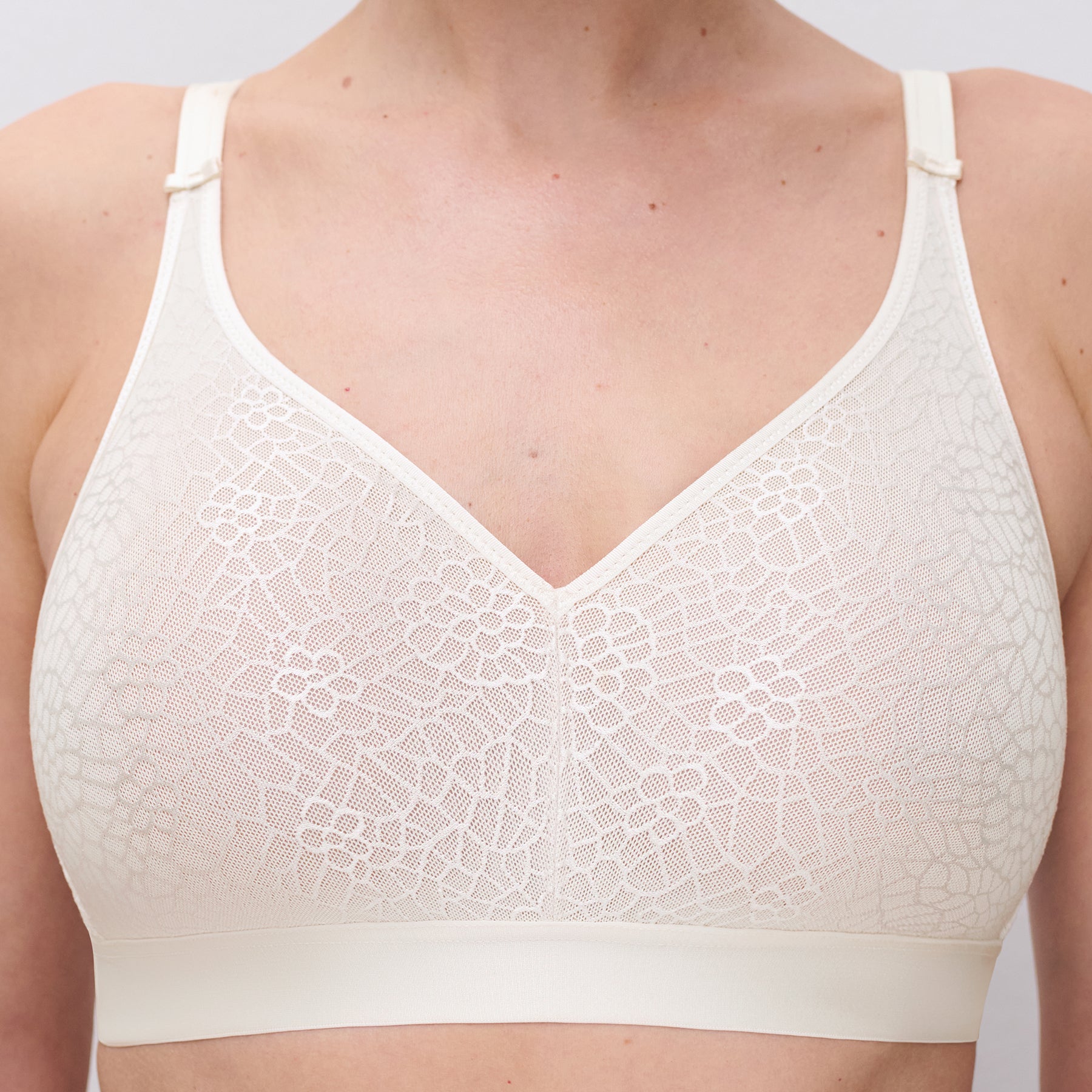 Chantelle C1892 C Magnifique seamless minimizing wireless bra in ivory 035. Front view close up on model.