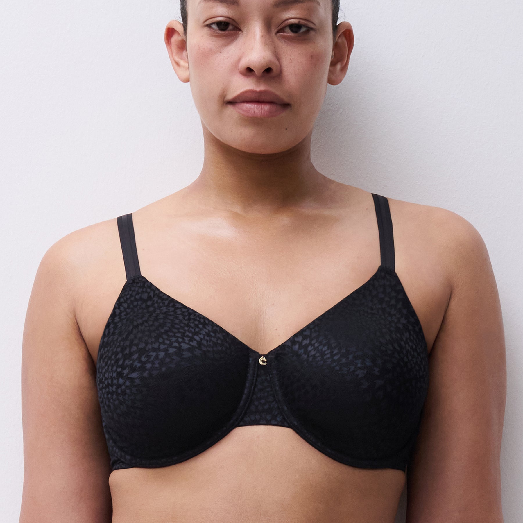 Front view of Chantelle C19UM1 Full Cup Magique Bra black – feminine design with gold charm detail at centre