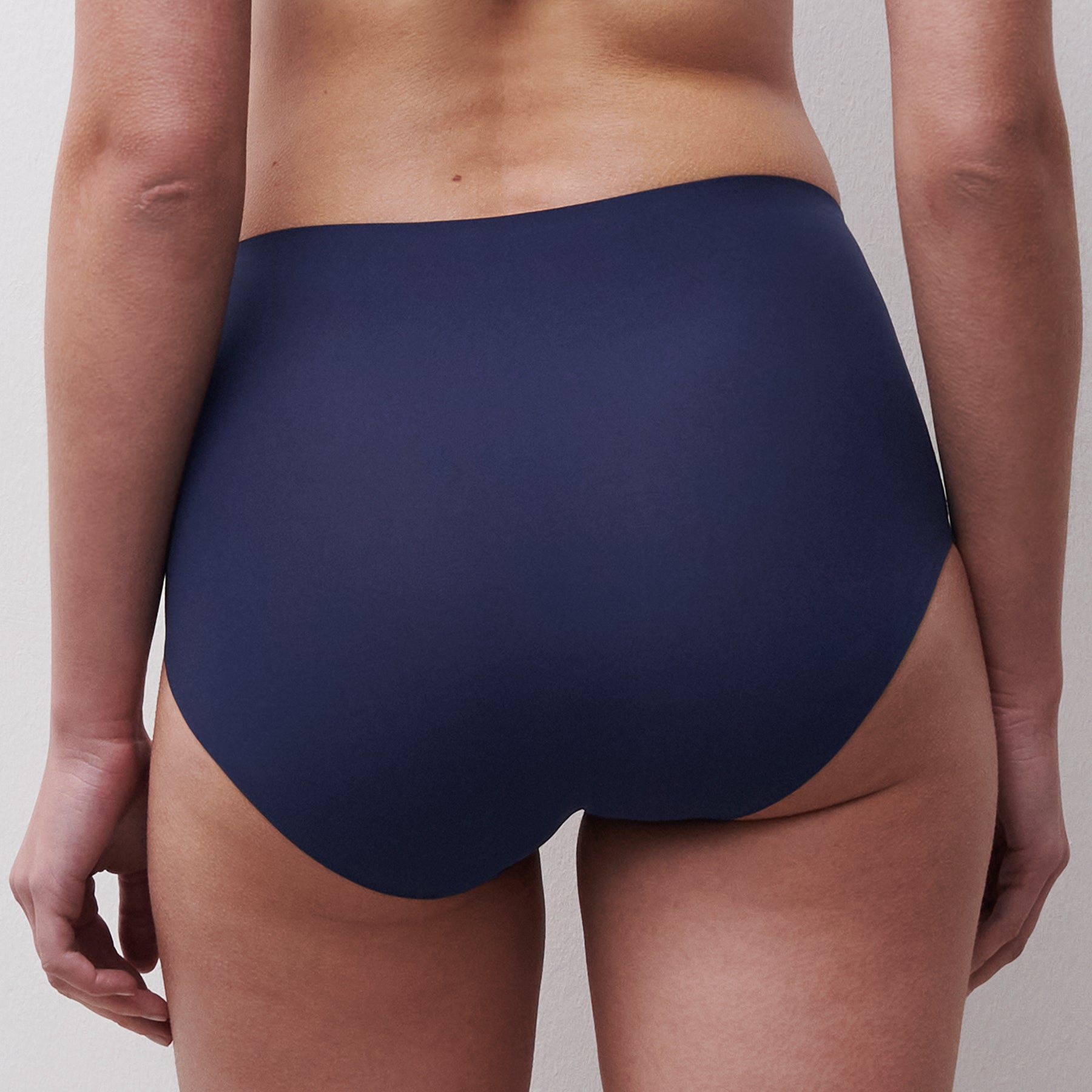 Back view of Chantelle Soft Stretch Full Brief in marine blue on model showing seamless coverage