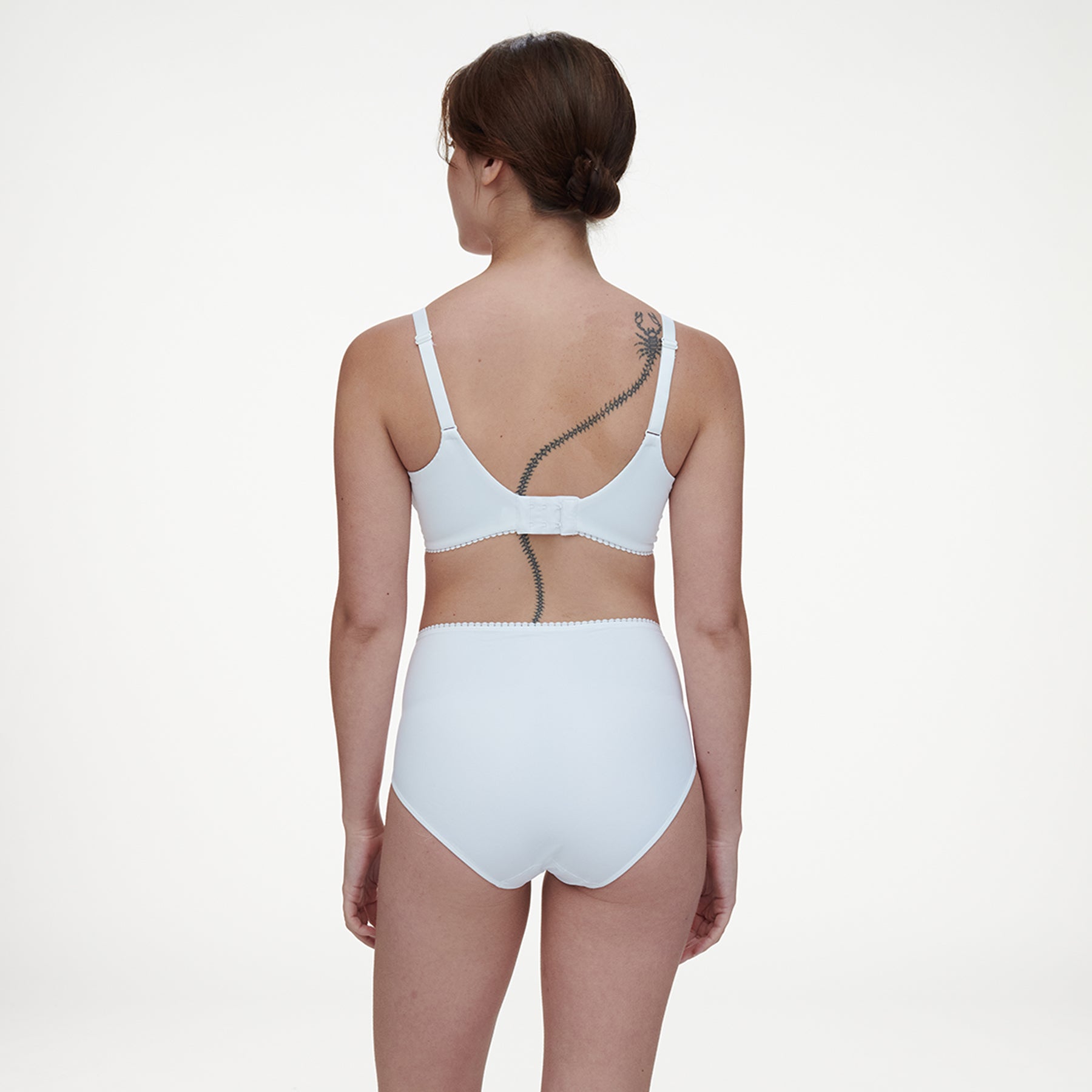 High waist full brief in white with knit front panels at hips. Rear view on model shown with matching full cup bra.