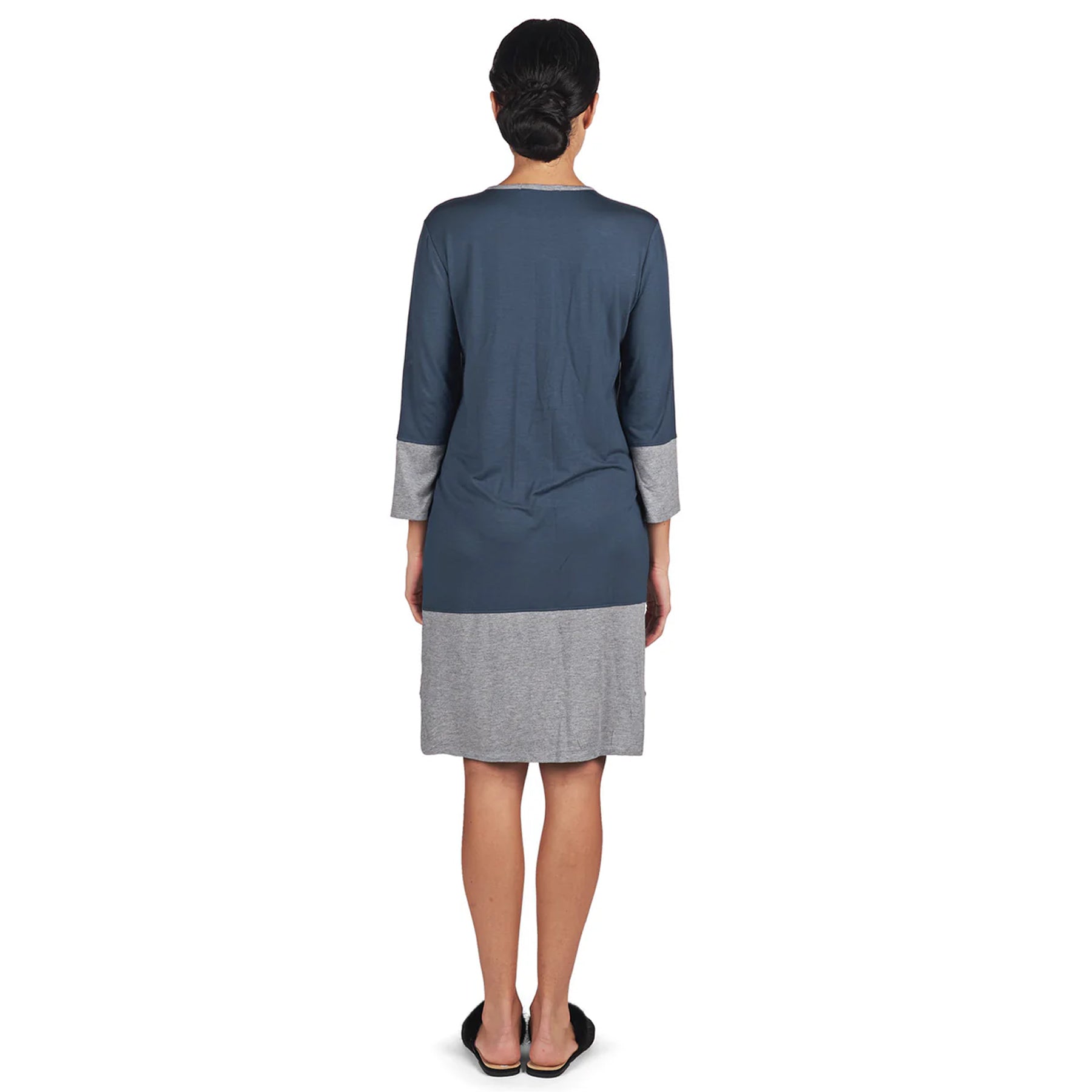 Back view of woman wearing soft midnight blue and grey colour-block nightshirt with straight hem.
