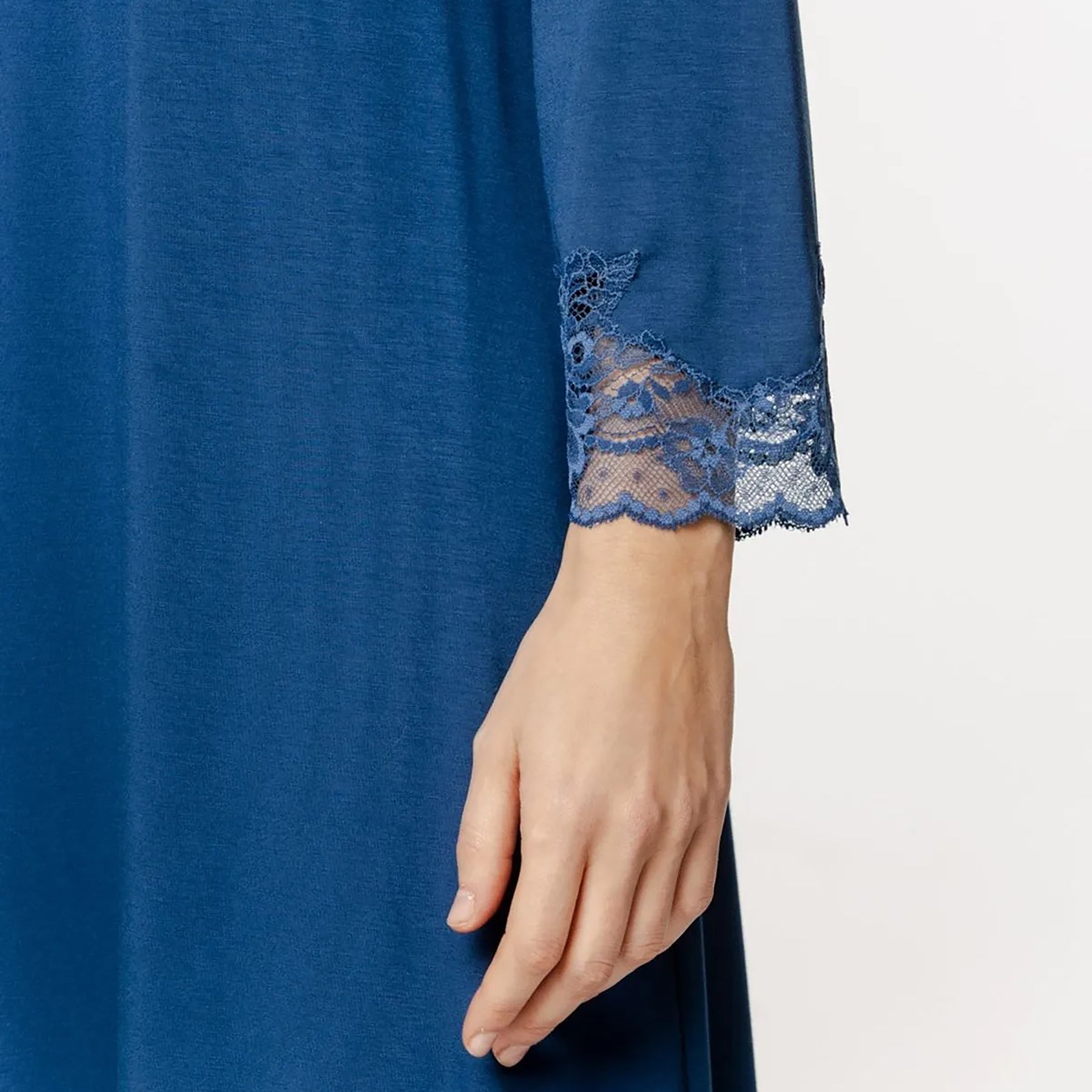 Detail shot of Coemi Seraphine chemise sleeve in Blue Jeans highlighting the intricate floral lace cuff.