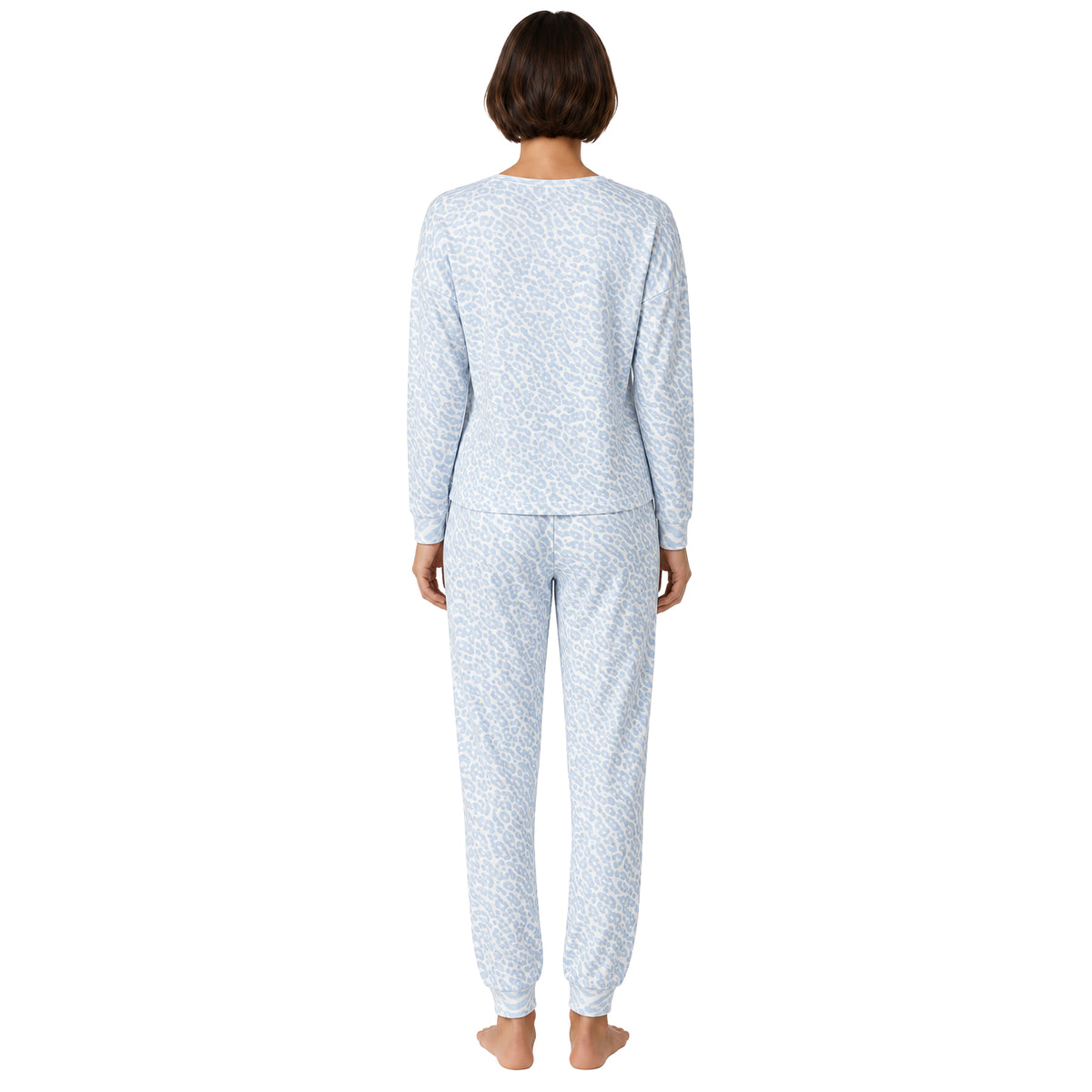 Model wearing a light blue leopard print pajama set with a long-sleeve top and matching jogger pants with cuffed ankles, back view.