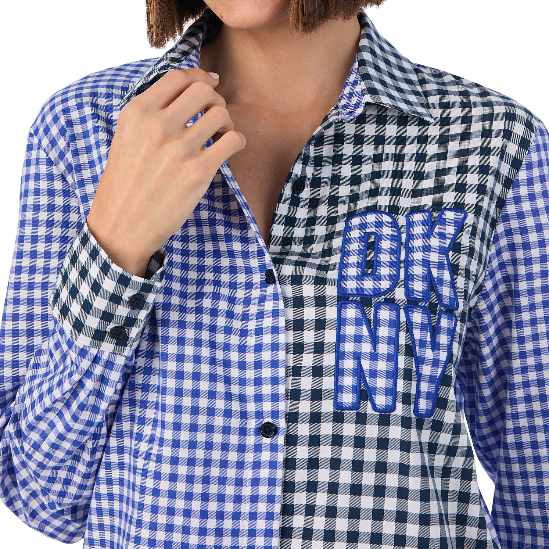 Long sleeve collared button up sleepshirt in blue and black checkered gingham print. Front view close up on model.