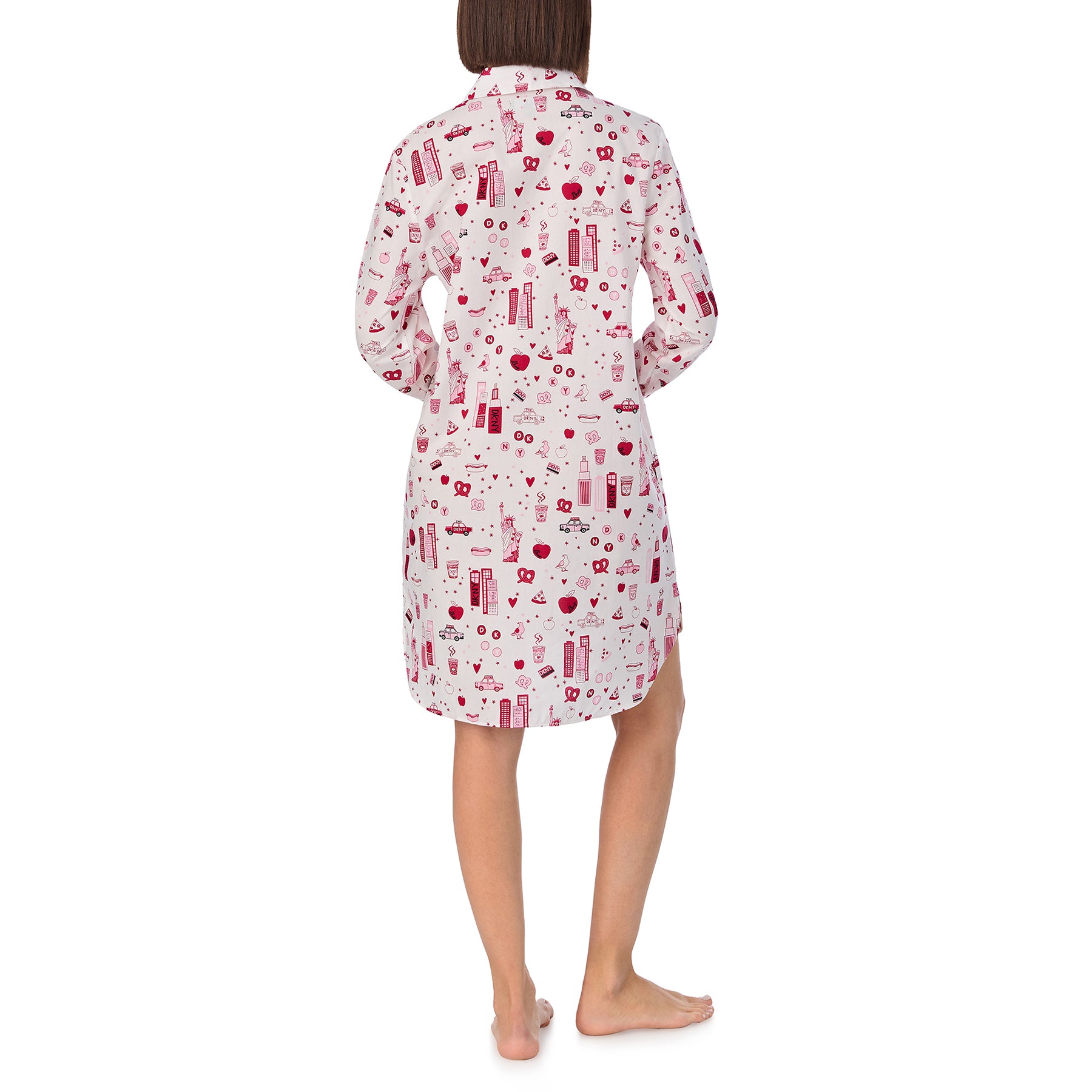 Long sleeve collared button up sleepshirt printed with new york city items in red and pink on a white background. Rear view on model.