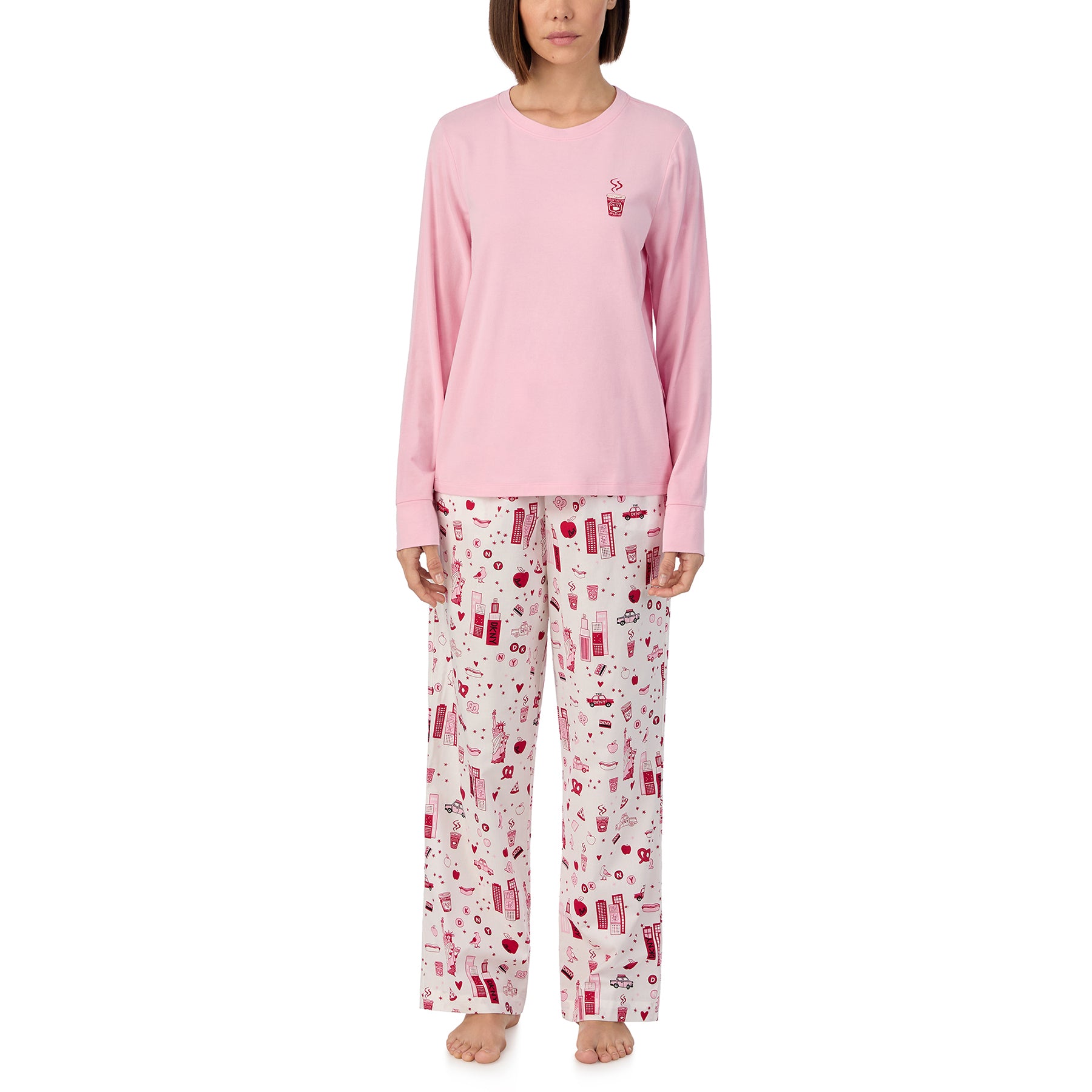 Long sleeve solid pink lounge top with matching pants printed with new york city items in red and pink on a white background. Front view on model.