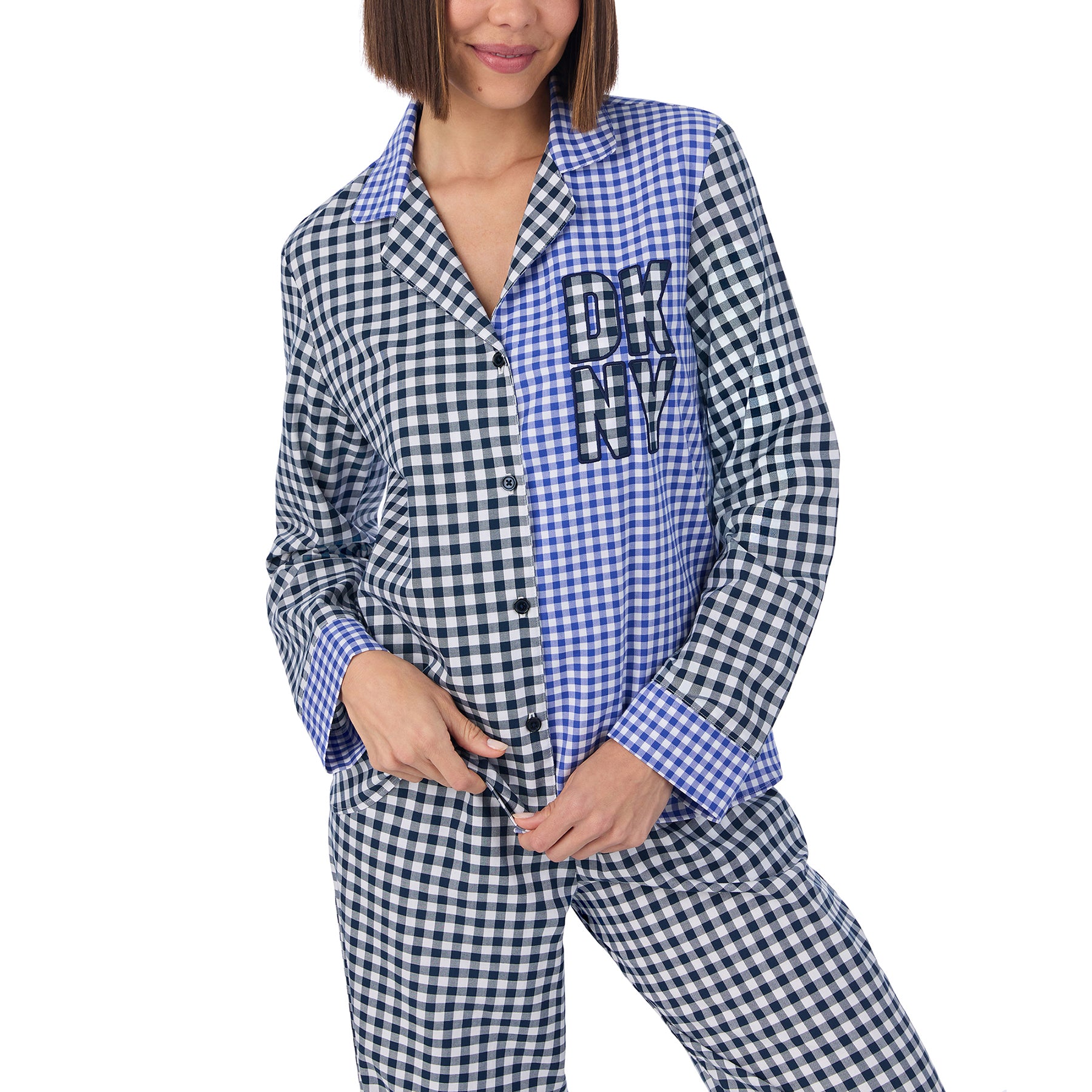 Classic 2-piece button up pyjama set in blue and black checkered gingham print. Front view close up on model.