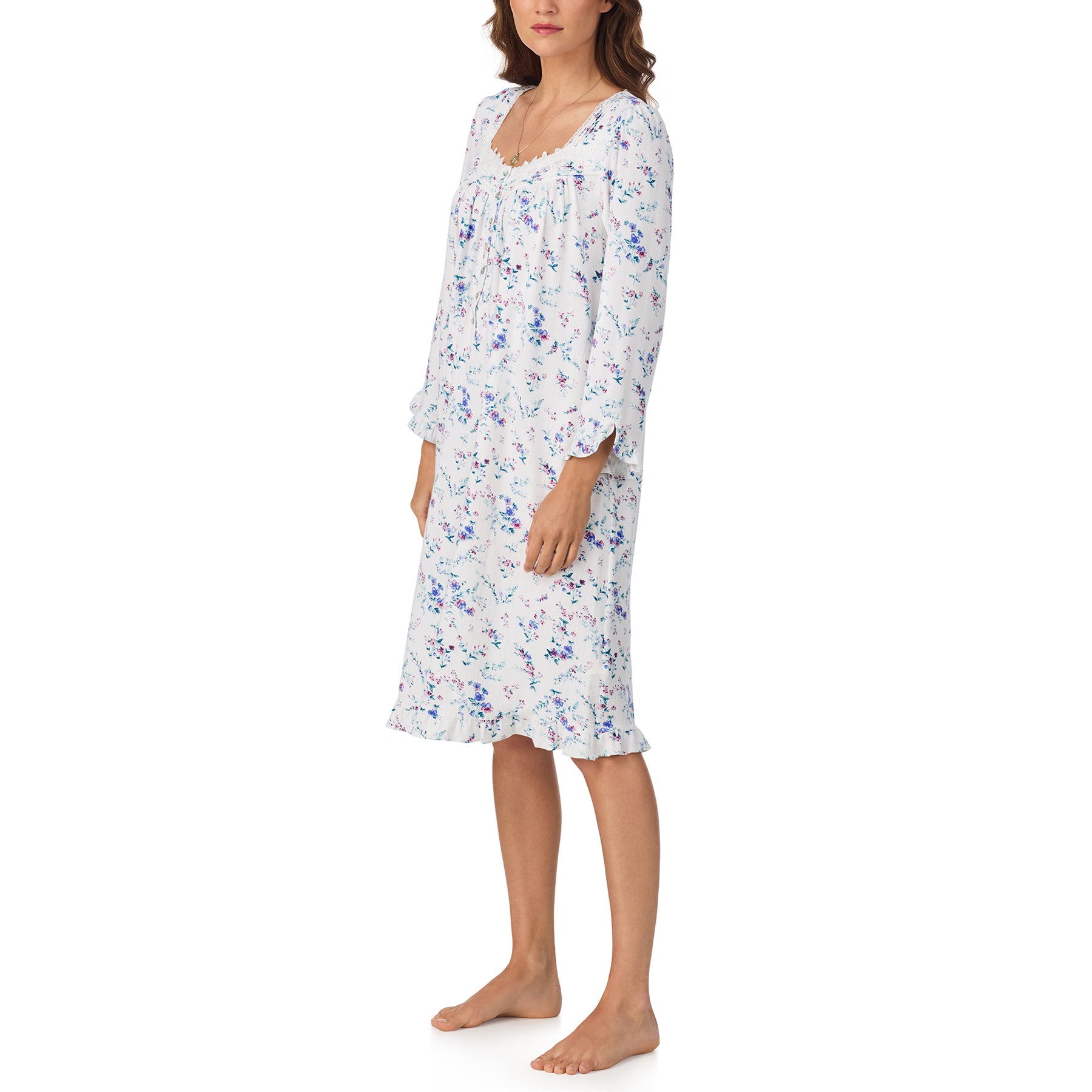 Woman wearing a floral nightgown on a white background