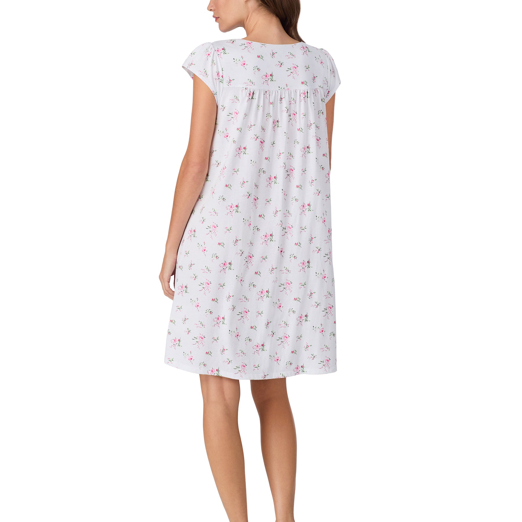 Back view of a white knee-length nightgown with short sleeves, gathered yoke, and an allover pink floral pattern.