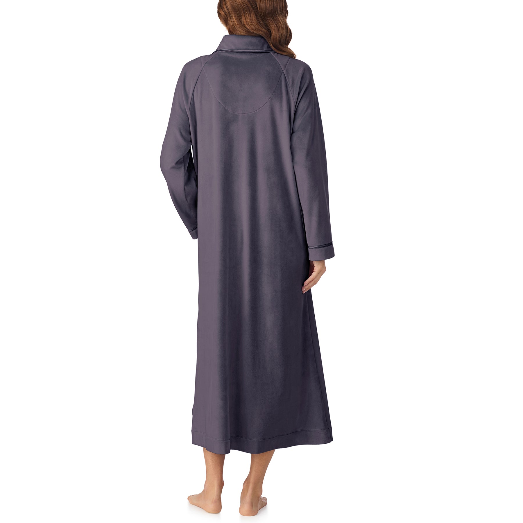 Back view of woman wearing long charcoal velour robe with collar and cuffed sleeves.