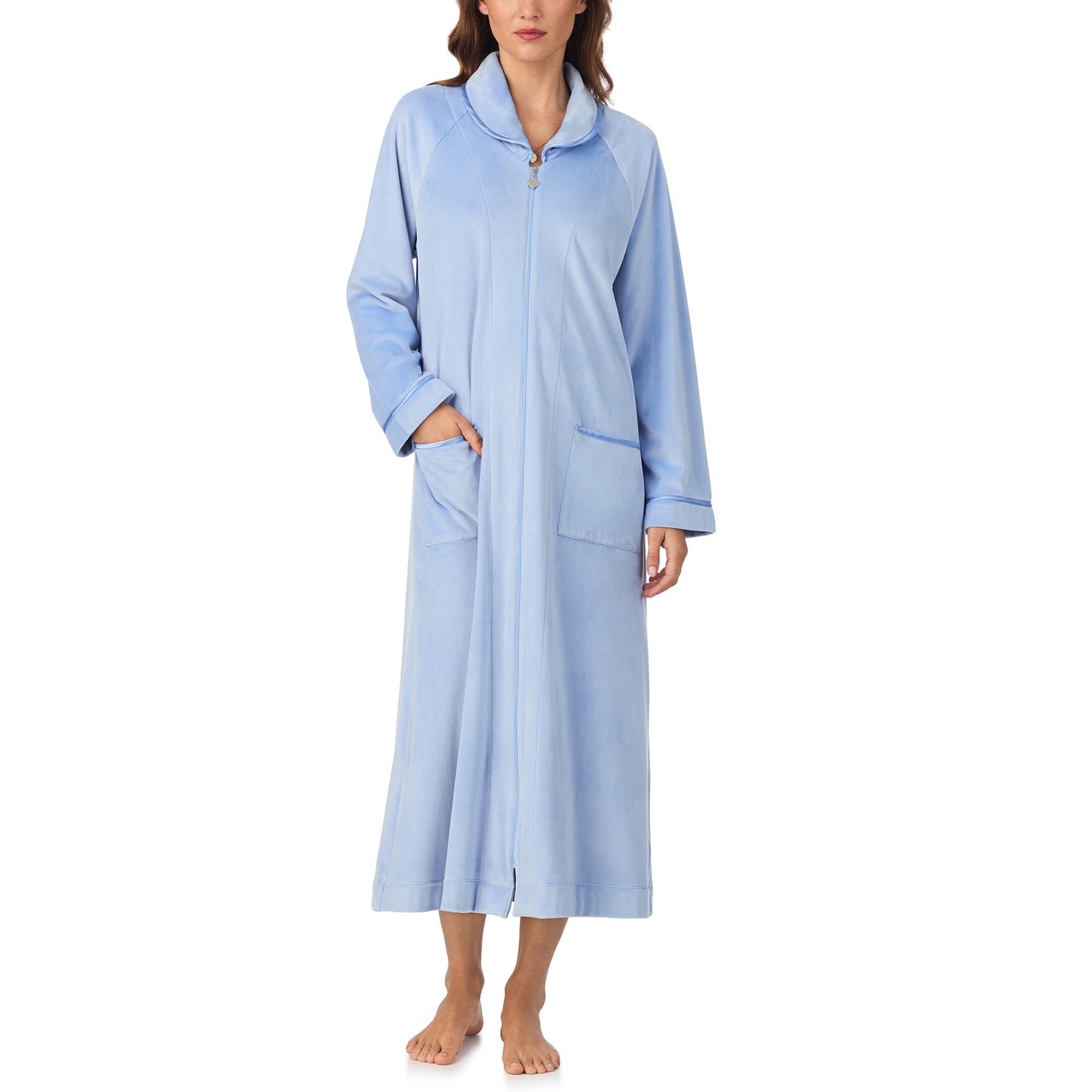 Woman wearing periwinkle blue velour robe with front zipper and relaxed fit, one hand in pocket.