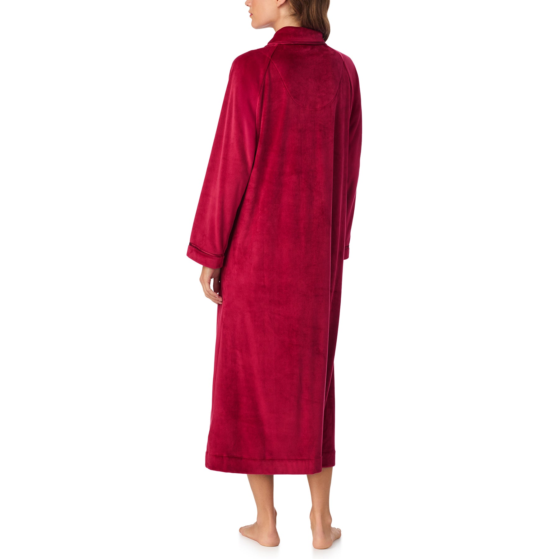 Back view of woman wearing long wine red velour robe with collar and cuffed sleeves.