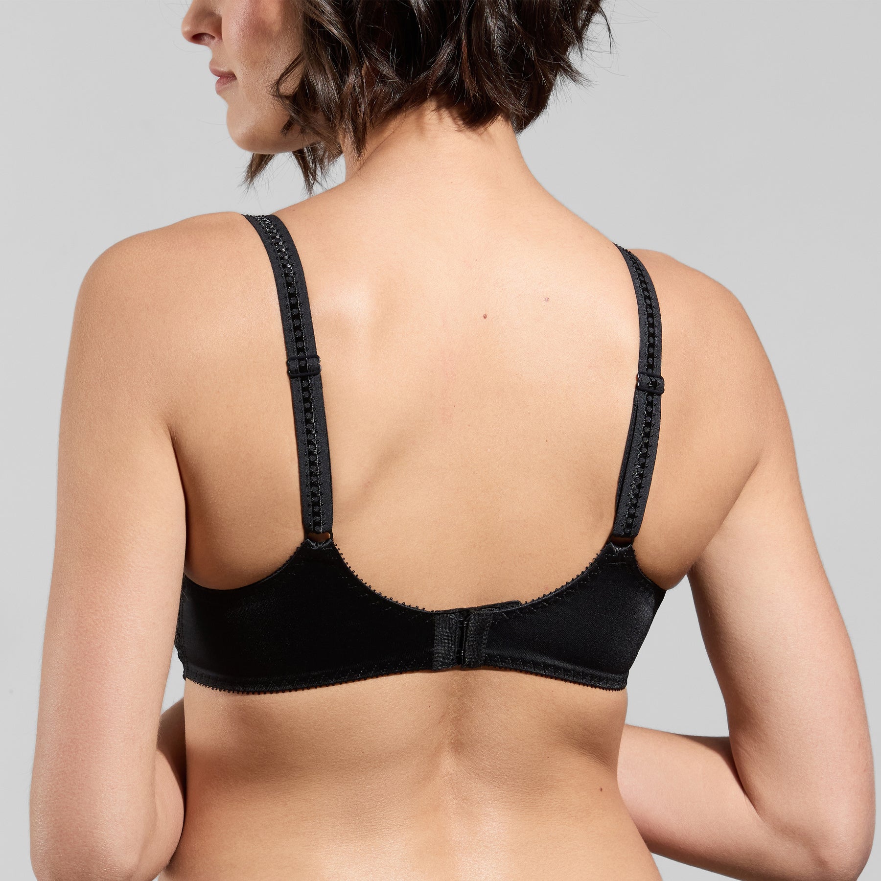 Back view of Empreinte Cassiopee molded full cup bra in black showing smooth band, adjustable straps, and hook-and-eye closure.