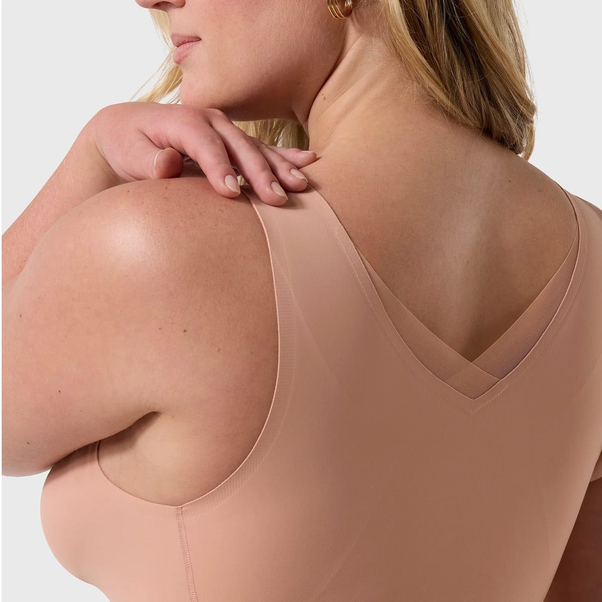 Close-up back view of the Evelyn & Bobbie Defy Wireless Bra Style 1865 in Himalayan Salt, highlighting wide shoulder straps, seamless back coverage, and V-shaped mesh neckline.