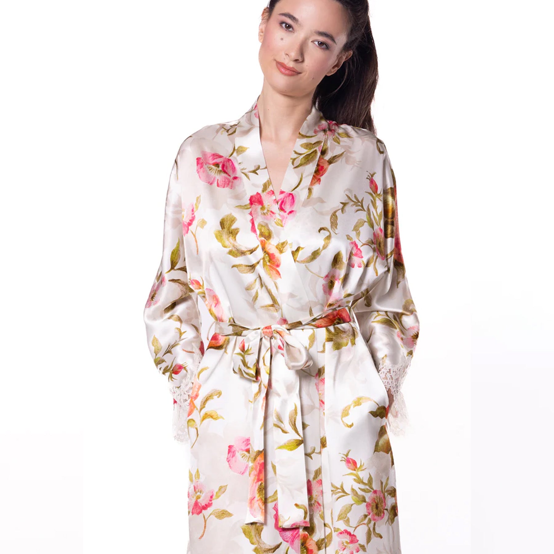Close-up of the floral silk robe showing the shawl collar, waist belt, and intricate lace trim on the sleeve cuffs.