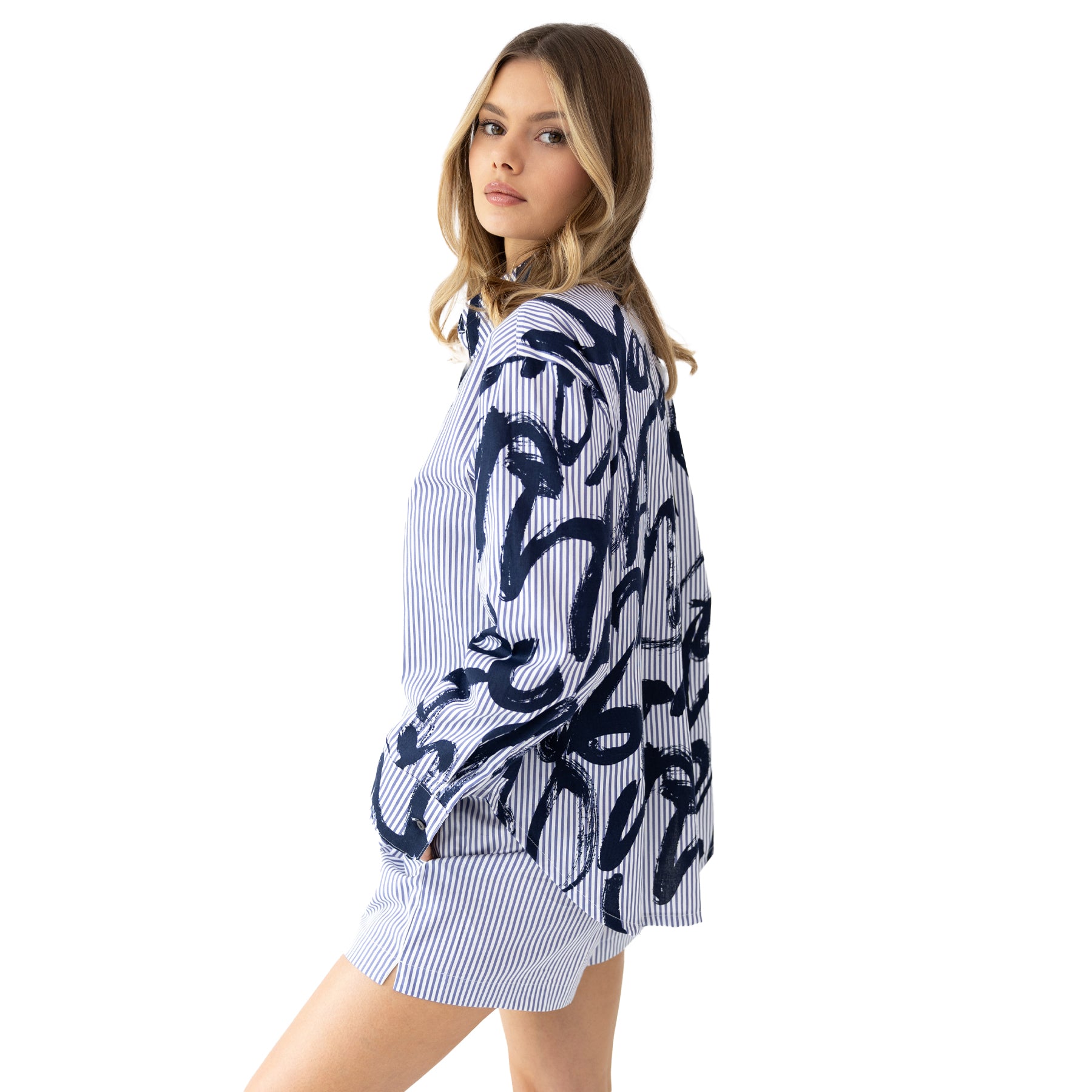 Side view of blue and white striped pyjama set with artistic navy print, lightweight fabric and relaxed fit