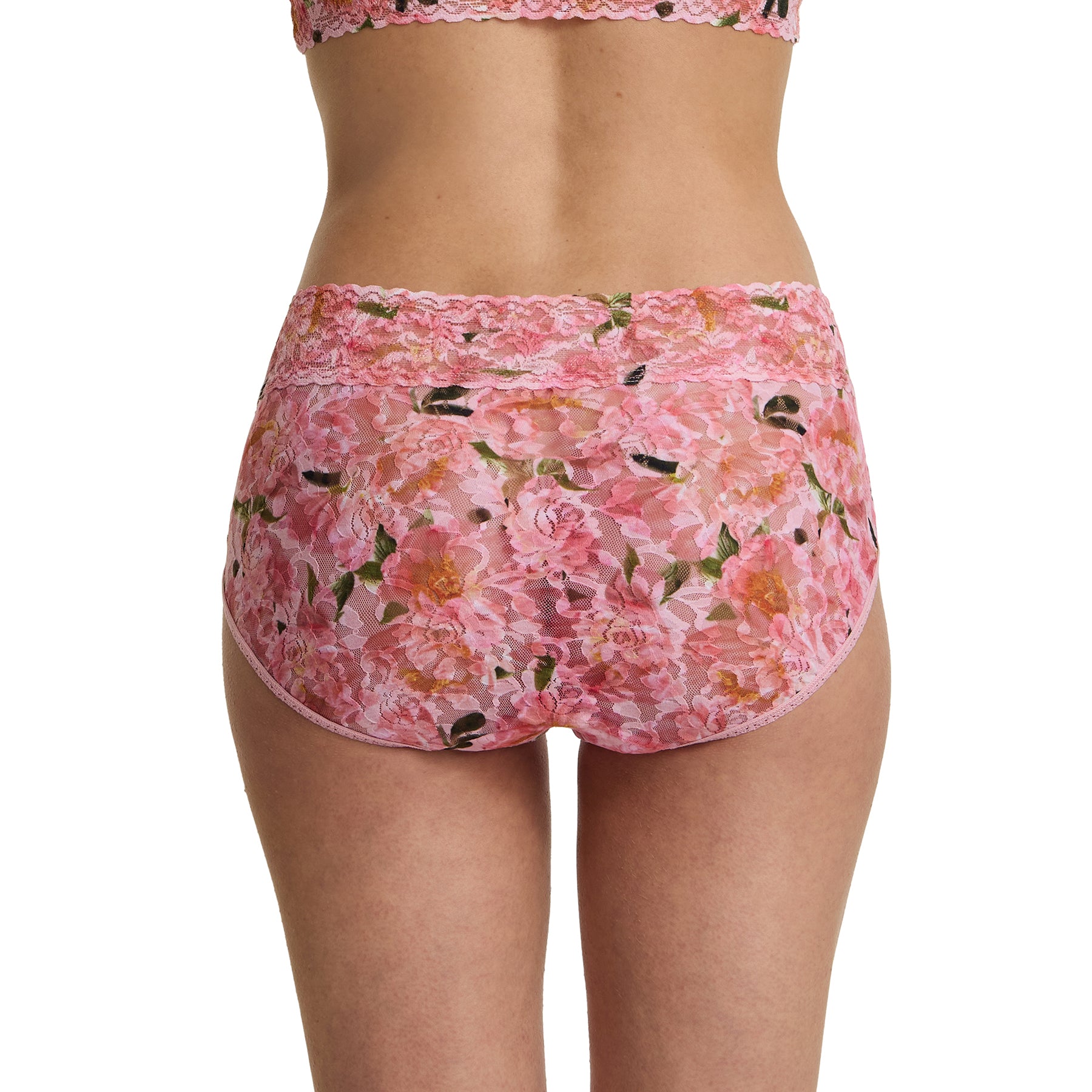 Back view of model wearing pink floral lace French brief in the Dancing Petals print with scalloped lace waistband and full coverage