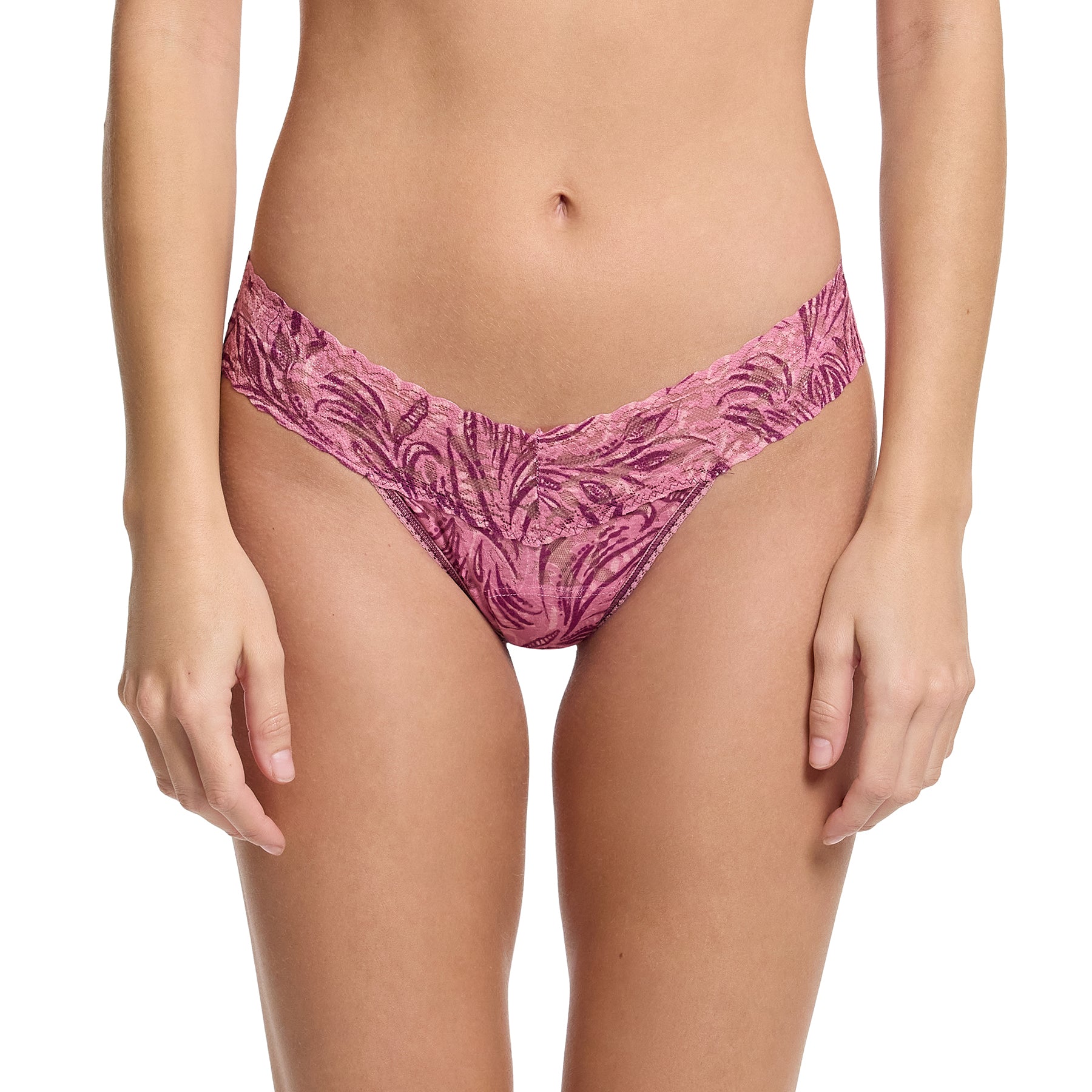 Front view of woman wearing Hanky Panky Low Rise Thong in In The Jungle – pink lace thong with deep plum jungle leaf print and soft V-cut waistband.