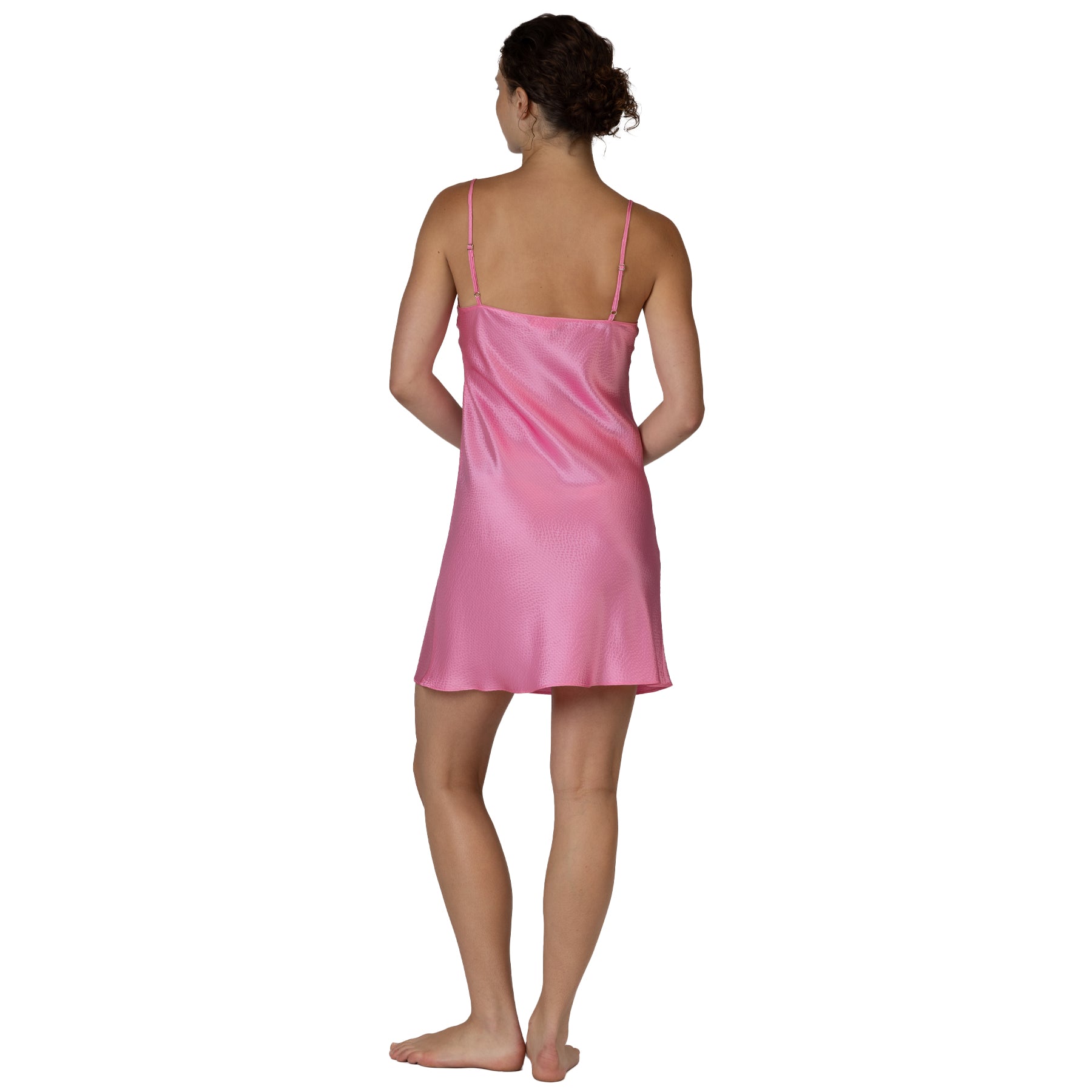 Pink satin slip nightdress back view with thin adjustable straps and smooth draped silhouette