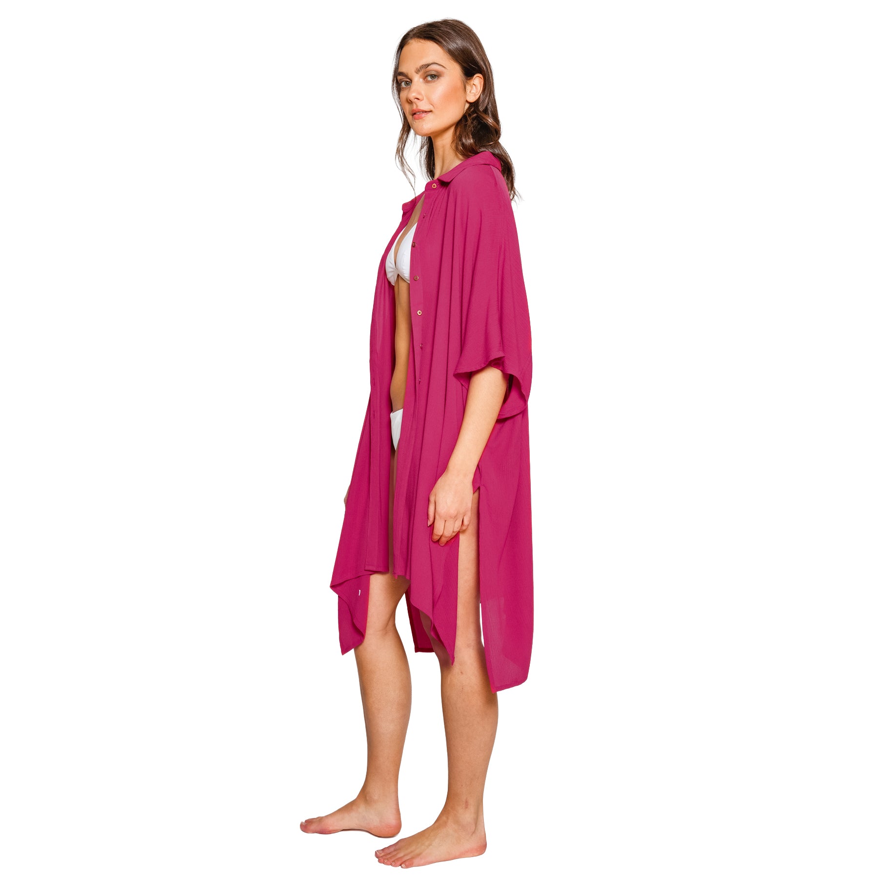 Side profile of Sangria pink swim cover-up featuring side slits, relaxed sleeves, and flowing resort-inspired styling.