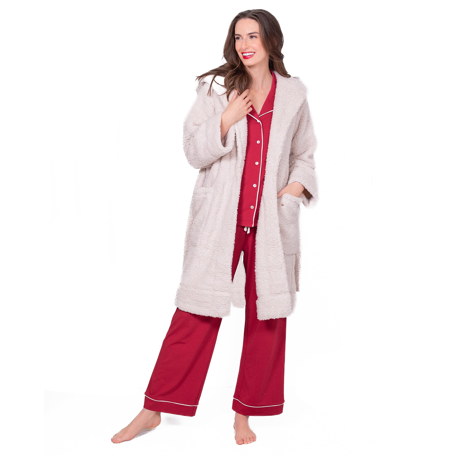 Woman wearing LatteLove plush hooded robe in cream, open front over red pyjamas.