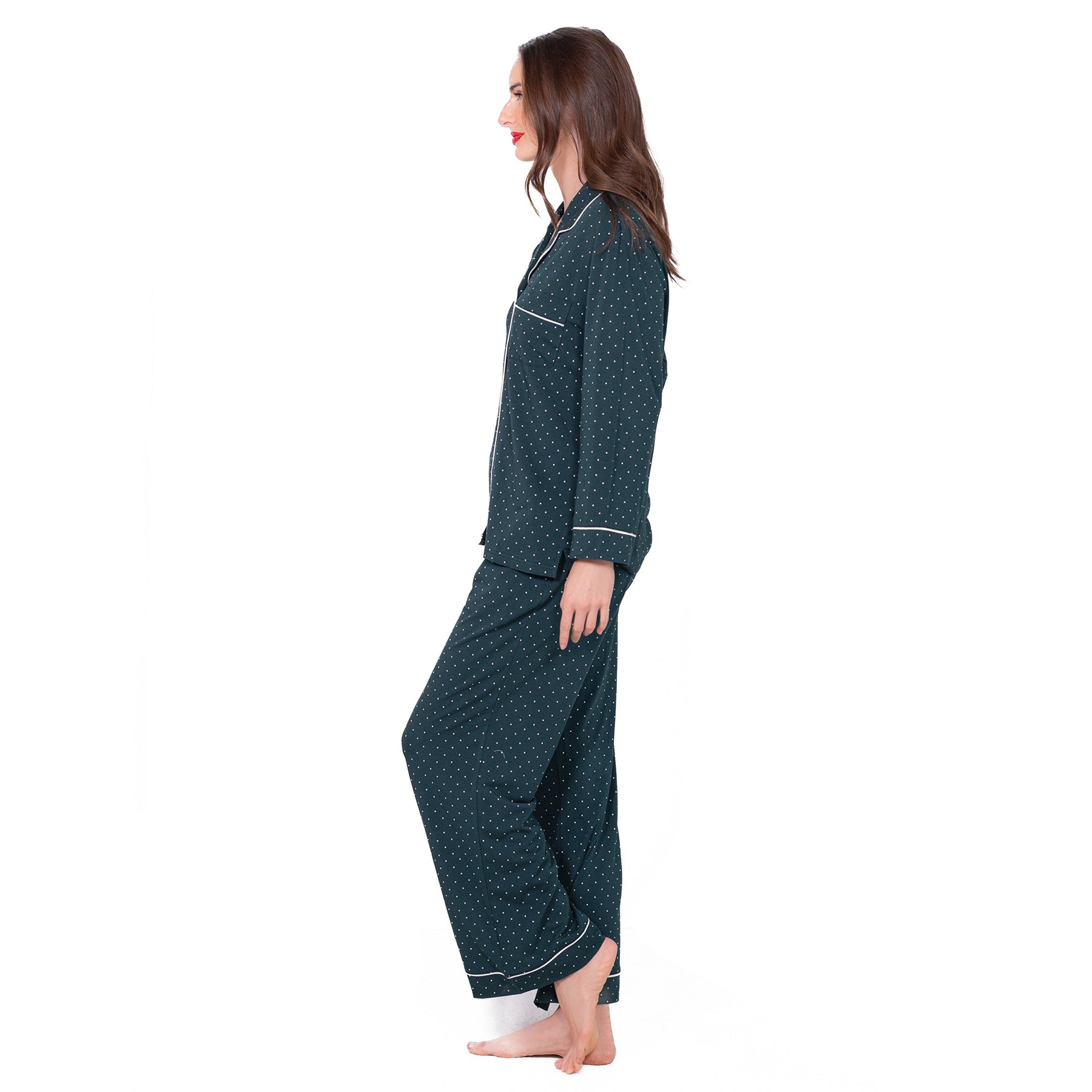 Side view of LatteLove women’s dark green pyjamas with small white polka dots and contrast piping.