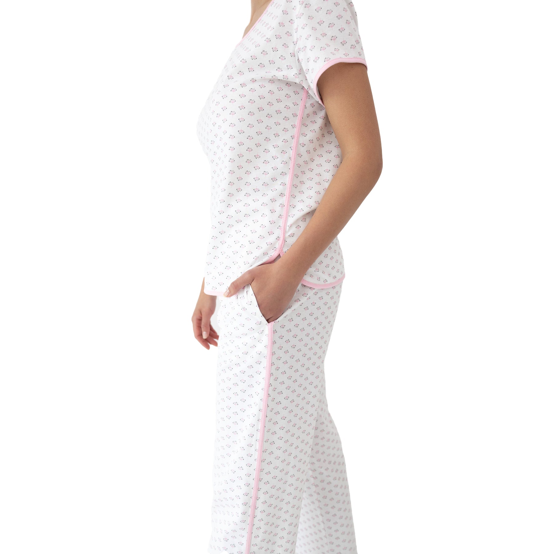 Side view of white and pink floral pyjama set with short-sleeve top, contrast pink piping, and comfortable straight-leg pants