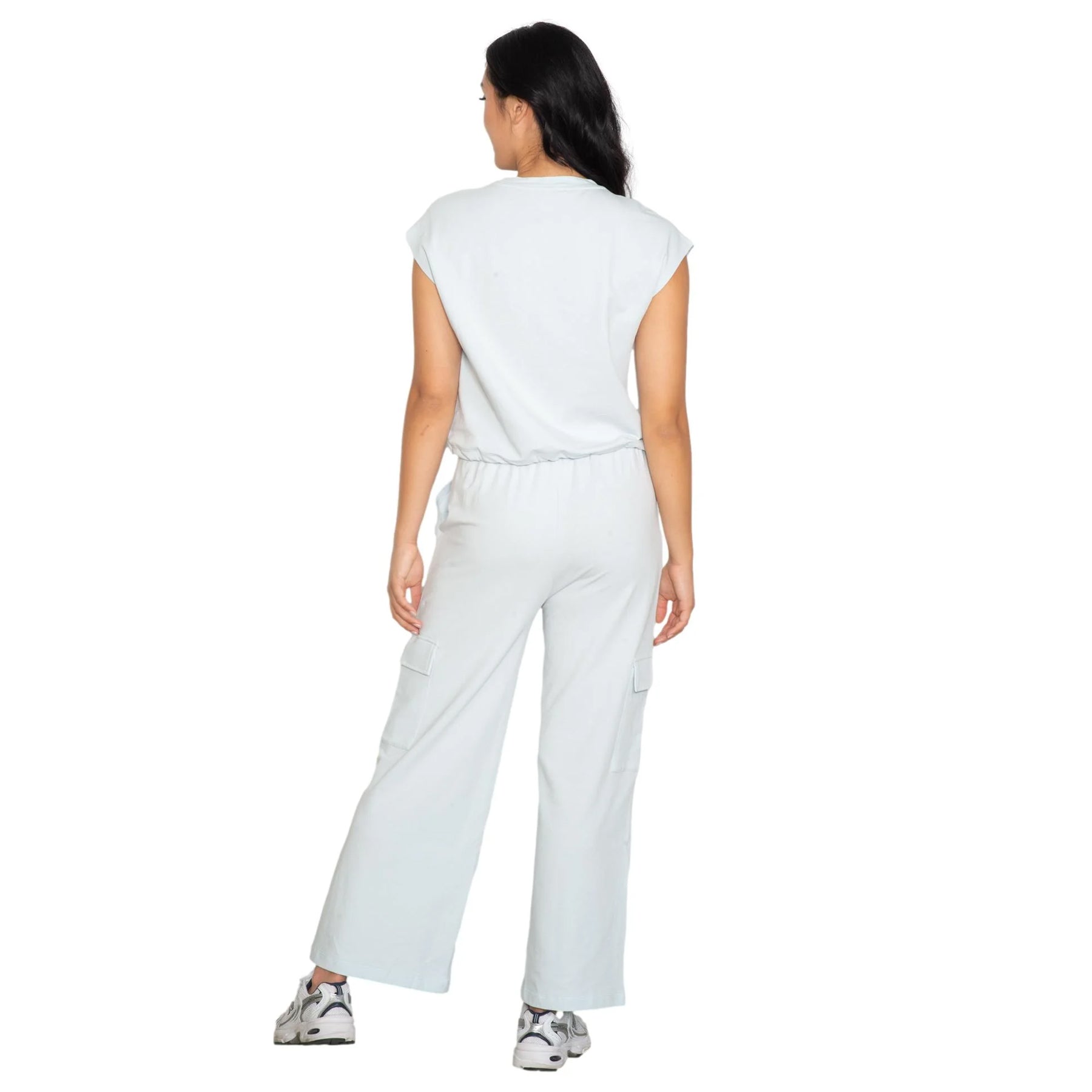 Pale blue casual jumpsuit with wide-leg silhouette, elastic waist, and utility pocket details, back view
