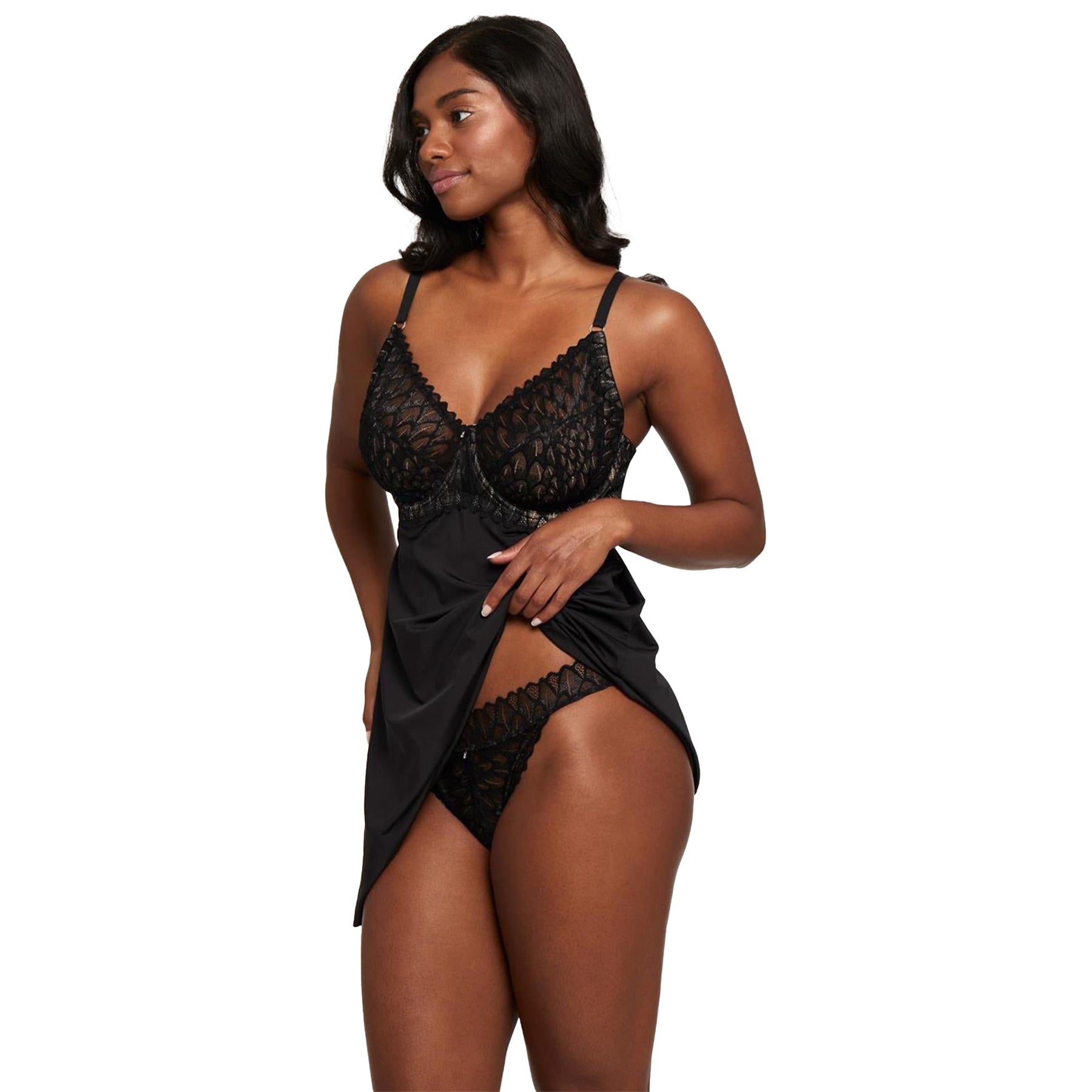 Montelle black lingerie set with embroidered babydoll chemise and matching G-string – model lifts skirt to reveal bottom piece, angled view.