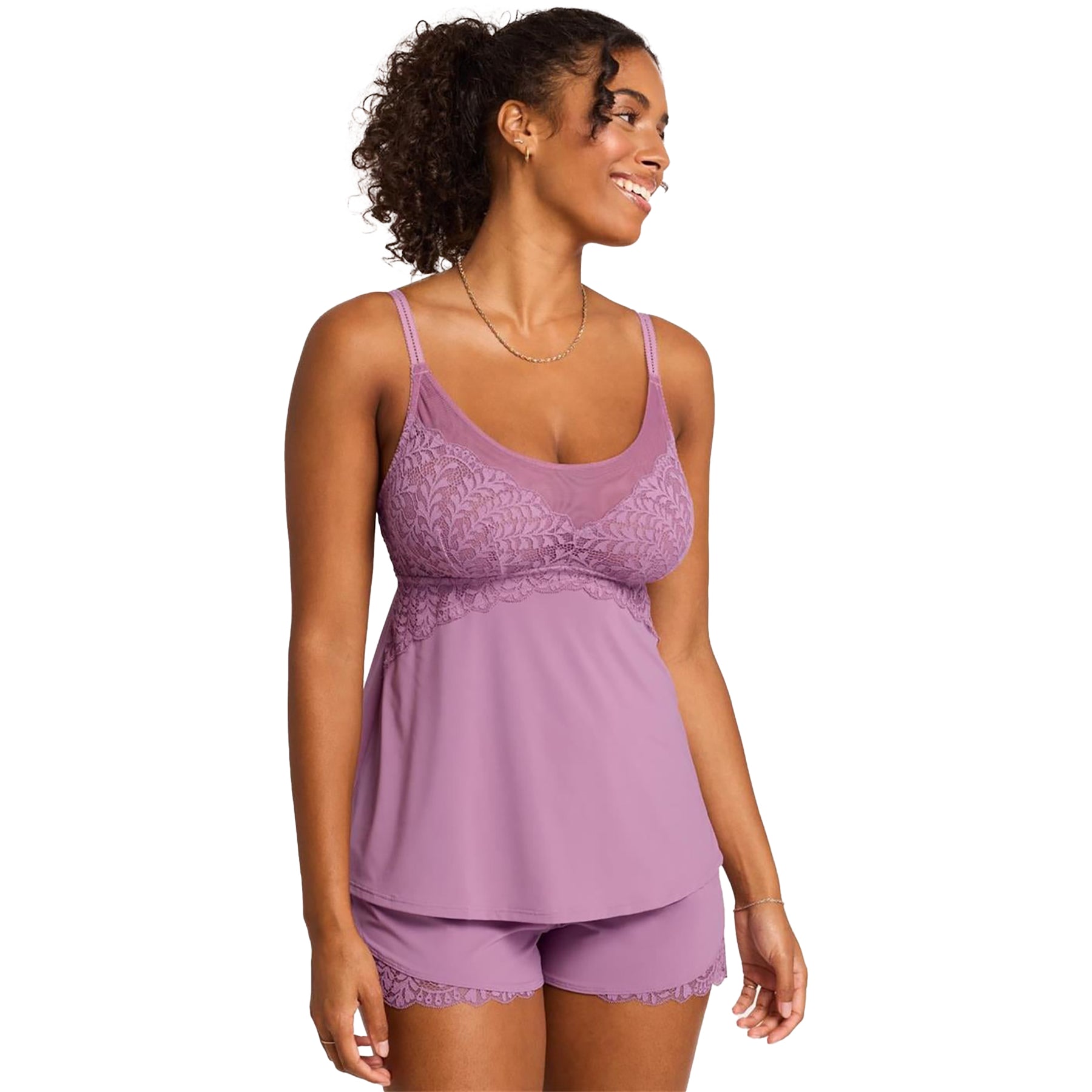 Woman wearing Montelle Berry Glaze cami and shorts pajama set with lace detailing – front view, smiling and looking to the side.