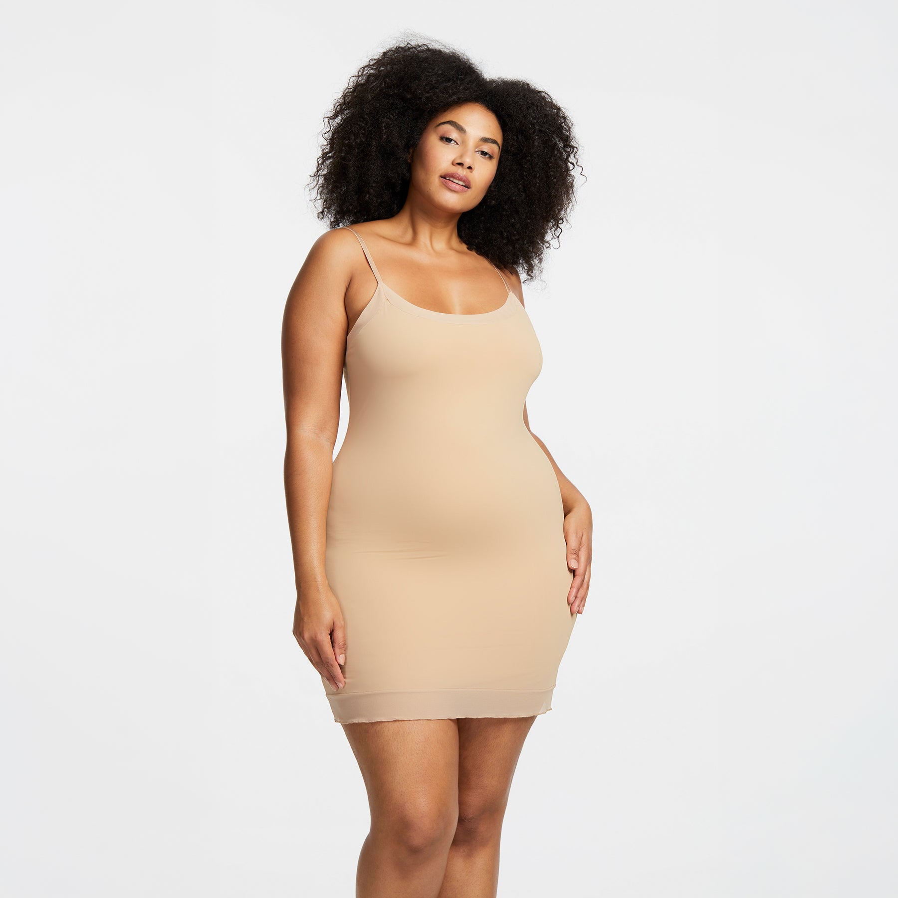 Montelle Intimates 9501 round neck slip above knee in Sand colour with smooth body-skimming fit and adjustable straps, front view on curvy model.