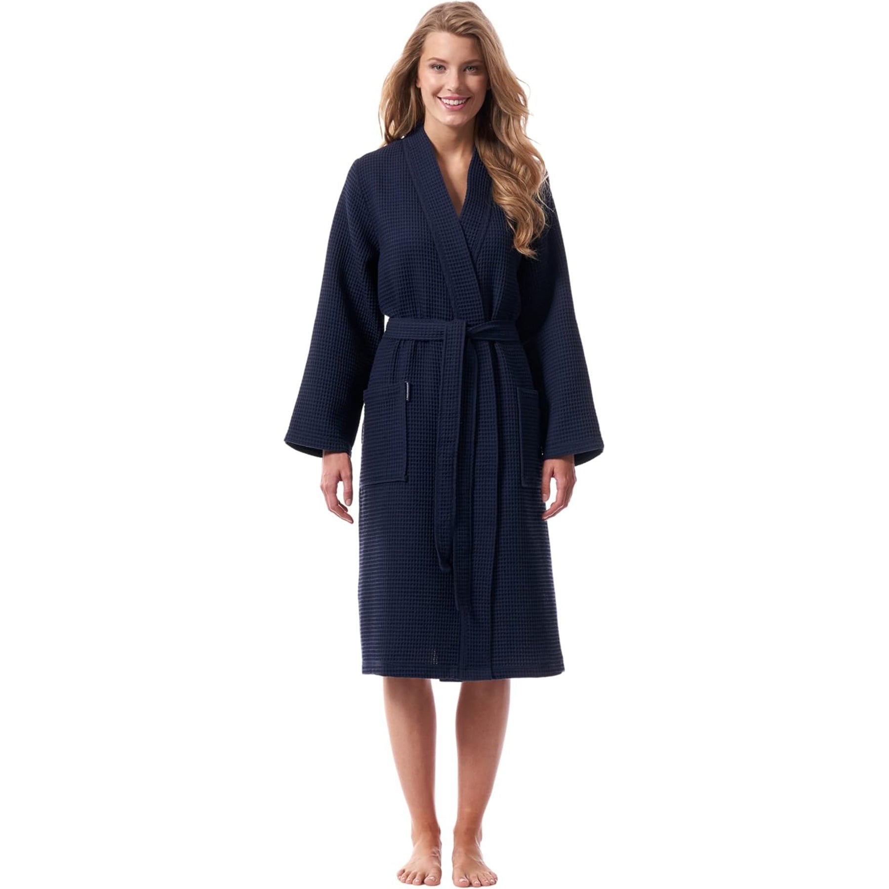 Woman wearing navy waffle bathrobe with shawl collar and belt – soft and breathable cotton robe.