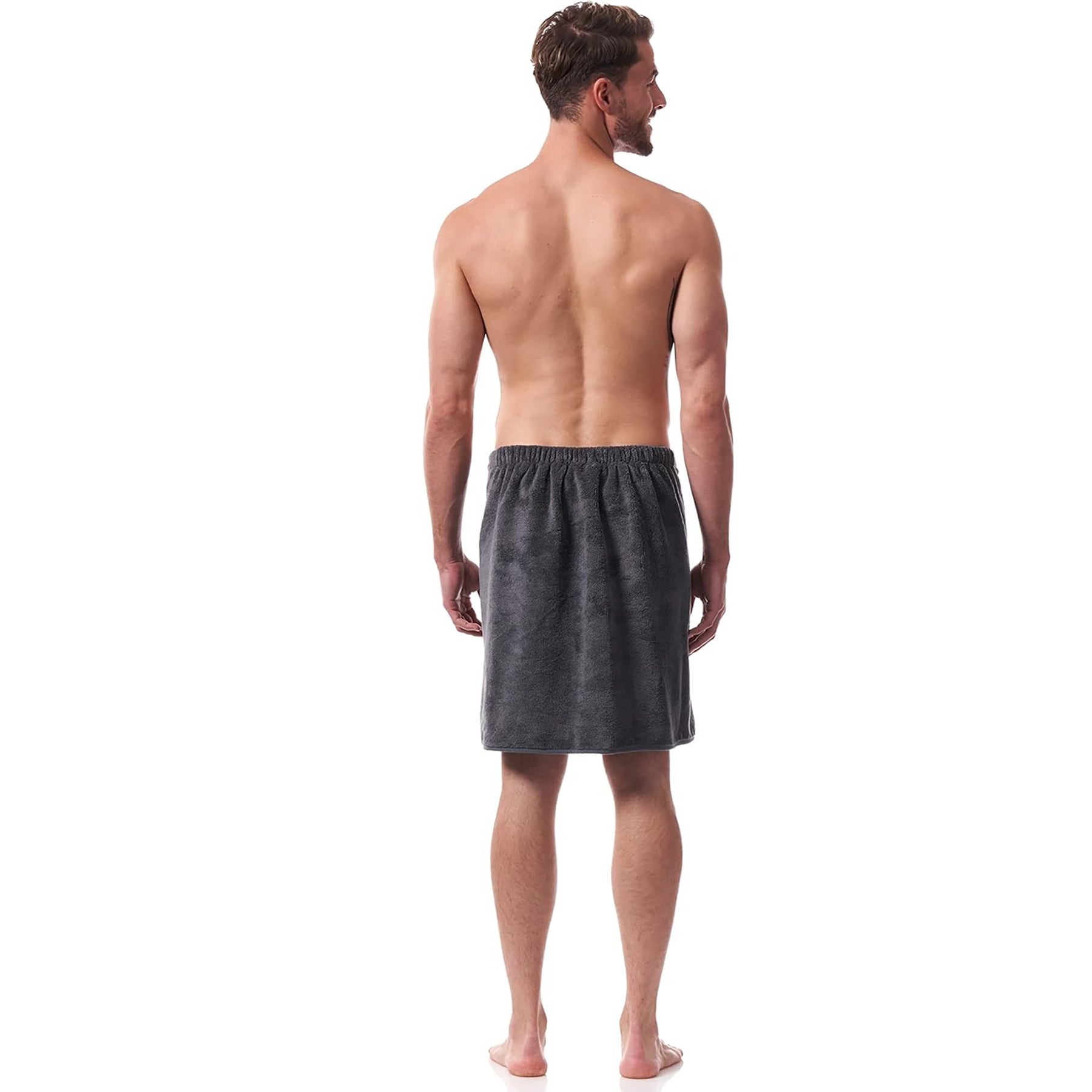 Man wearing charcoal grey men’s towel wrap – lightweight, soft, and secure for spa, beach, or home use. Rear view.