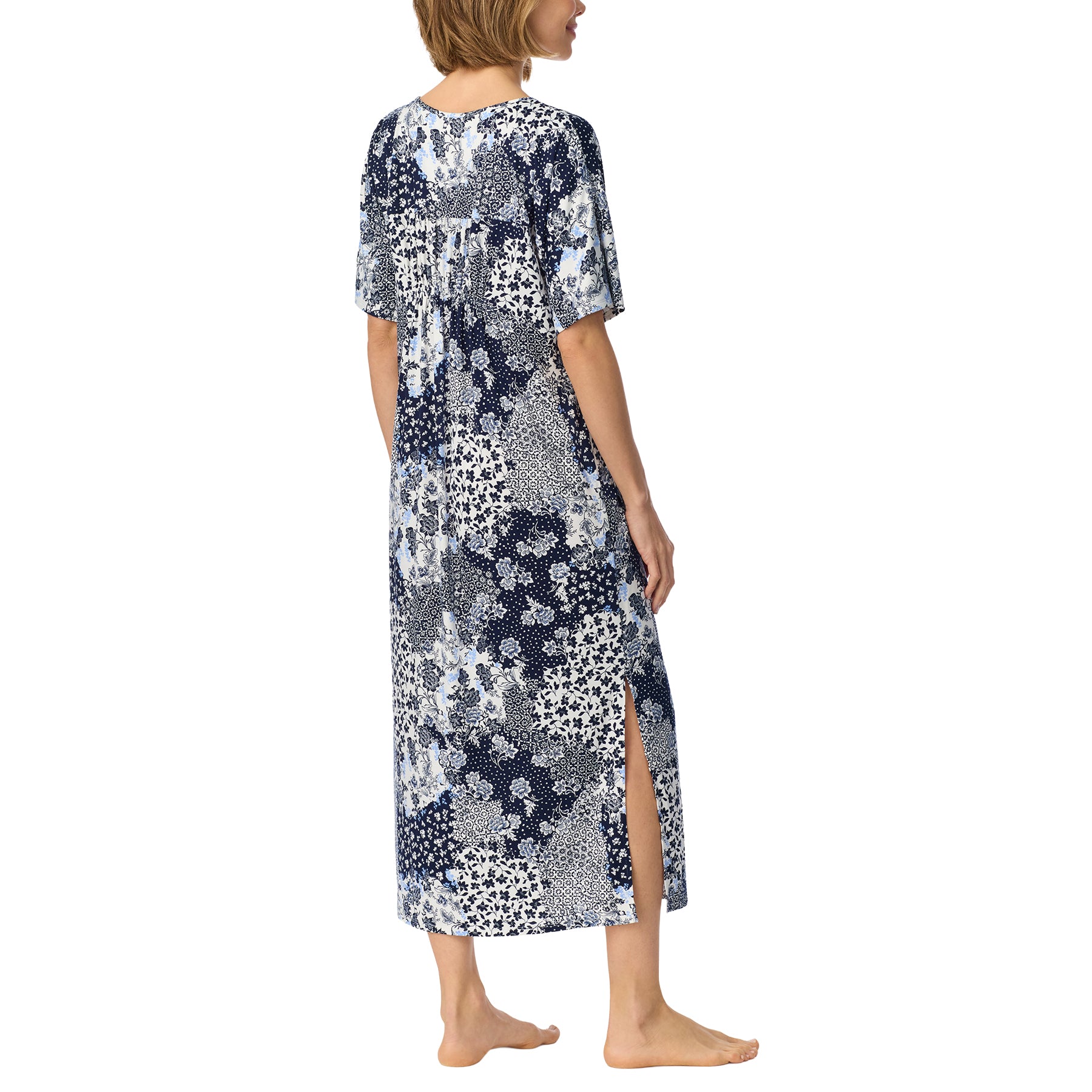 Back view of navy, white and soft blue patchwork floral nightgown with short sleeves and a side slit at the hem.