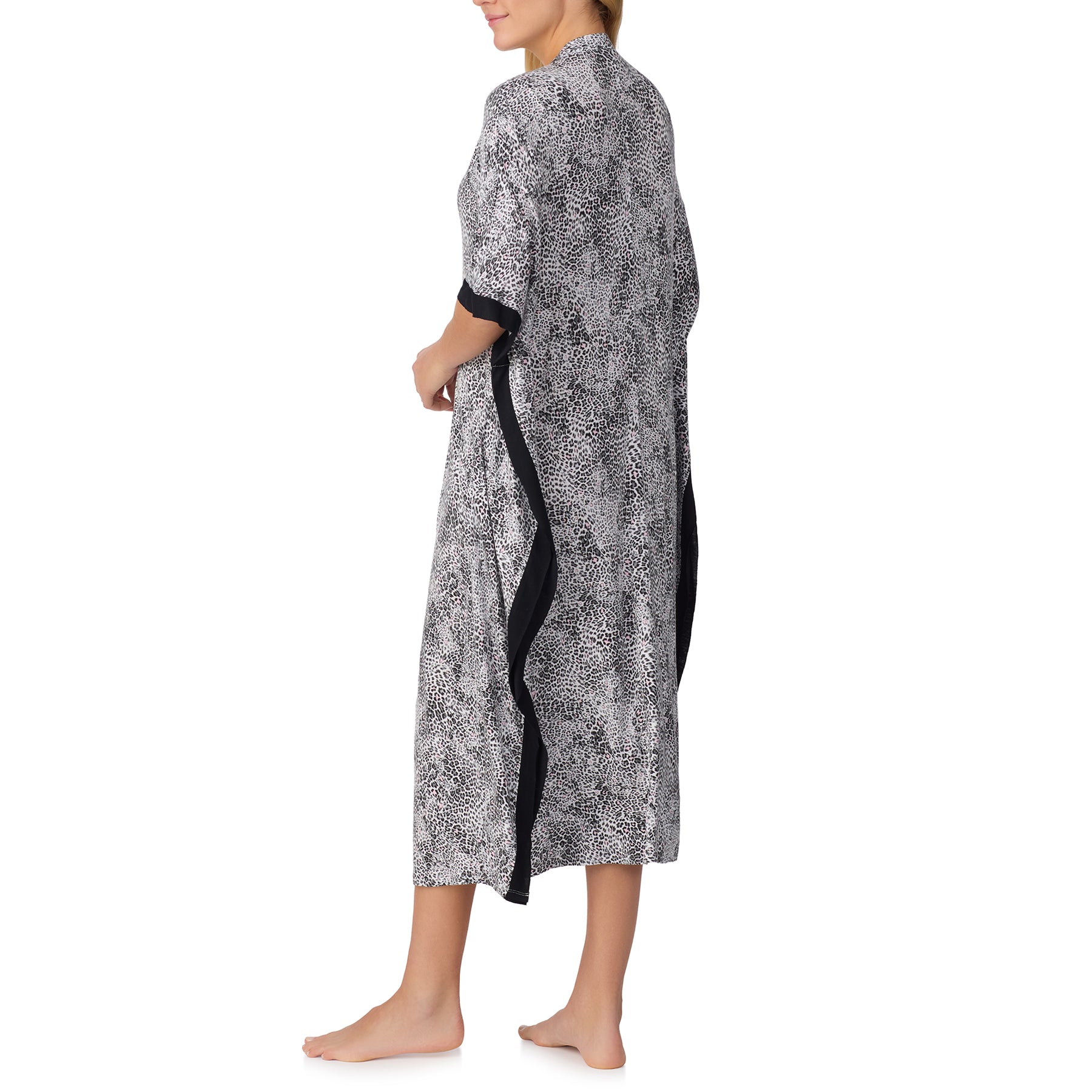 Back view of women’s long leopard print kaftan with black trim and relaxed flowing fit