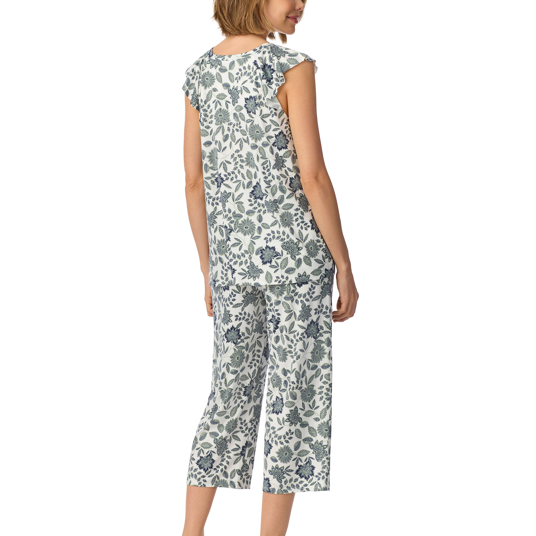 Back view of a floral pajama set with a relaxed-fit top and cropped pants, showcasing an all-over blue botanical print on a soft white background.