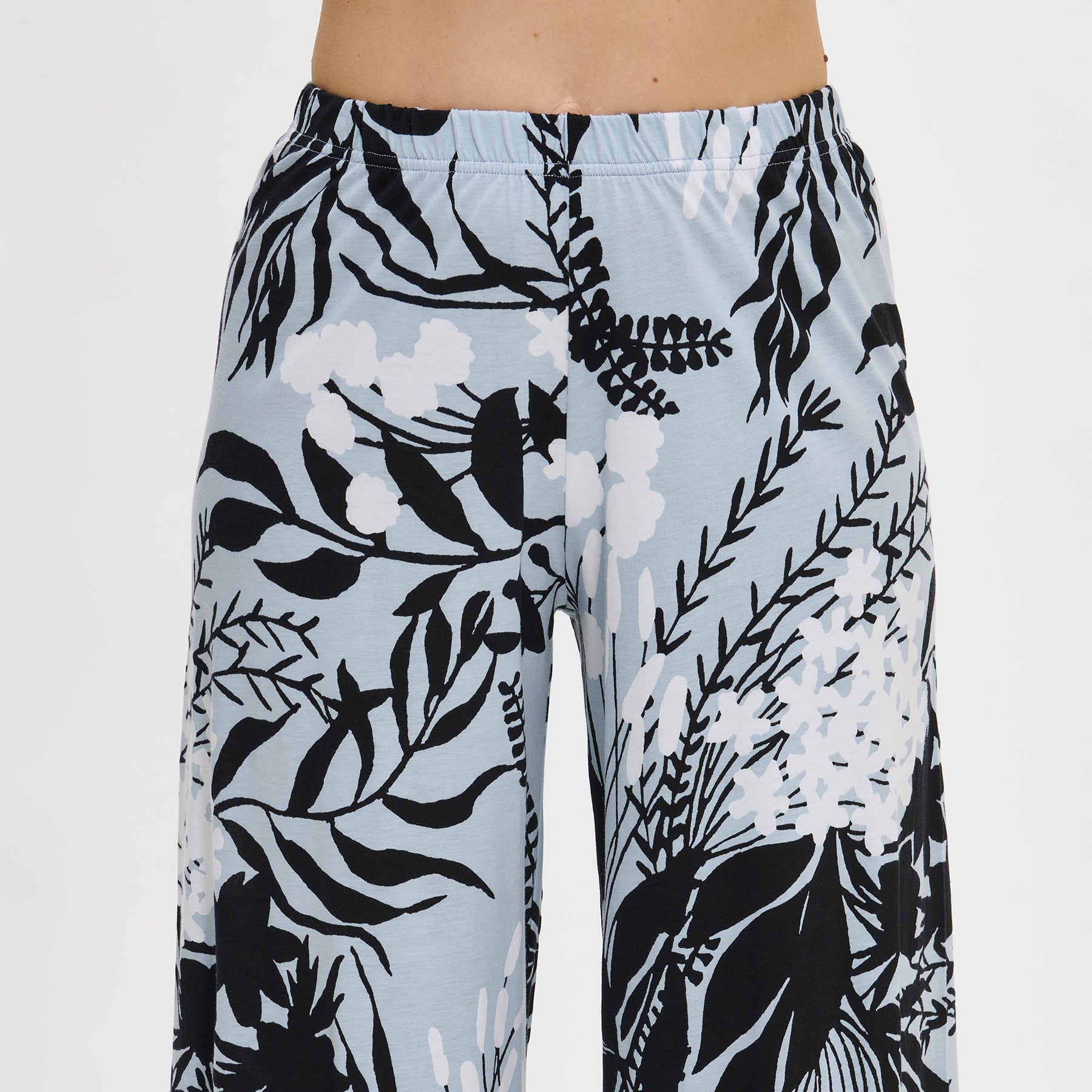 Detail of Nanso cropped cotton pants in grey with black-and-white floral design