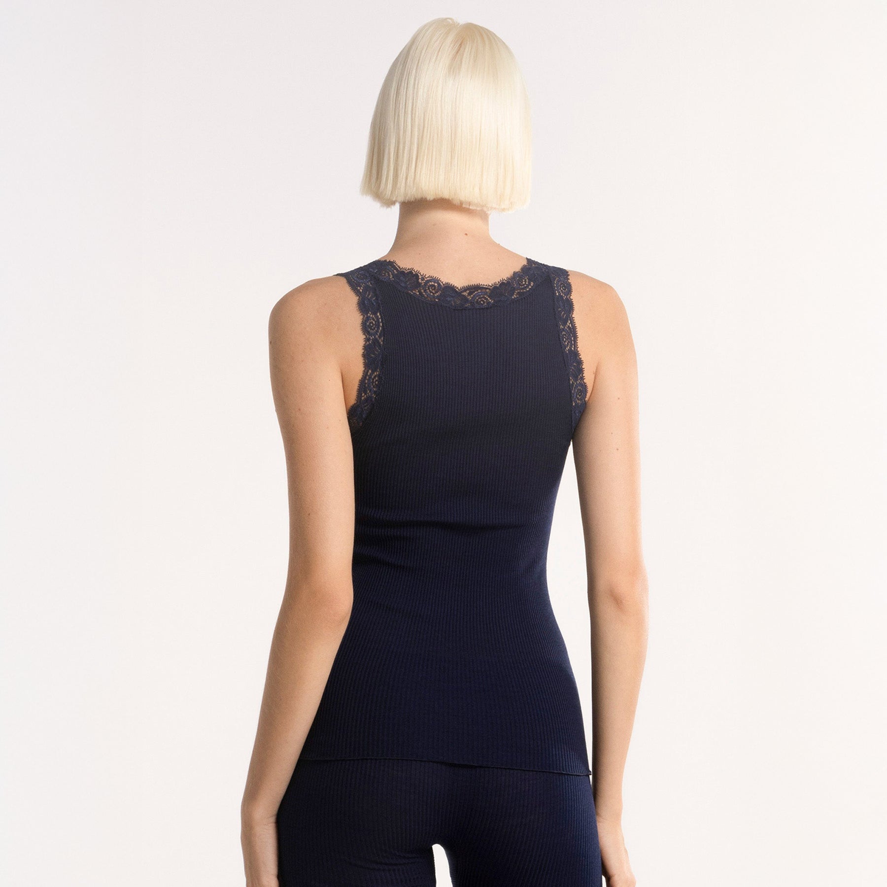 Back view on model of Oscalito 3410 Lace Trim Ribbed Tank in Bleu Marine – Italian-made navy camisole with lace straps and soft ribbed knit texture.