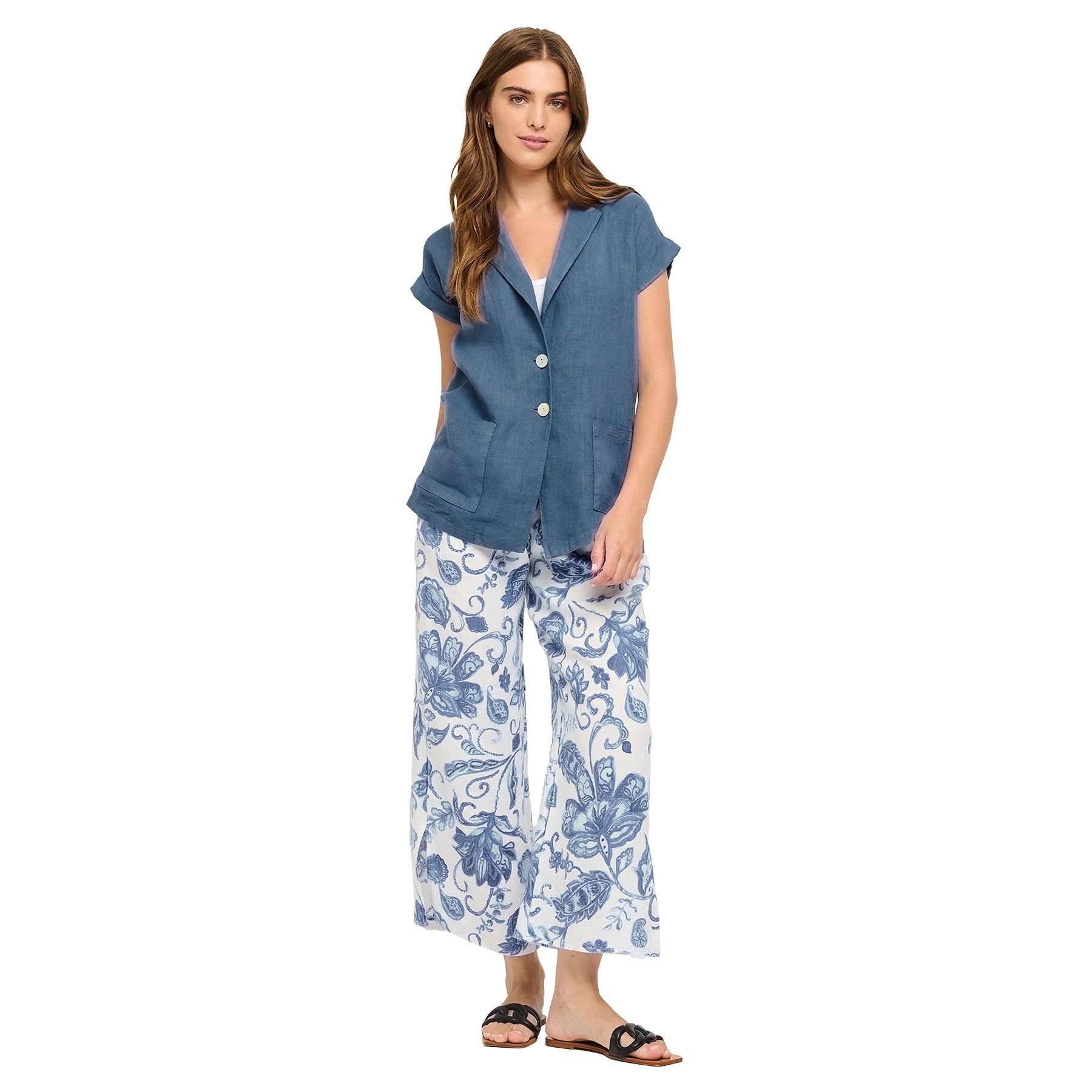 Azure summer print blue floral linen pants with split leg hem. Front view on model.