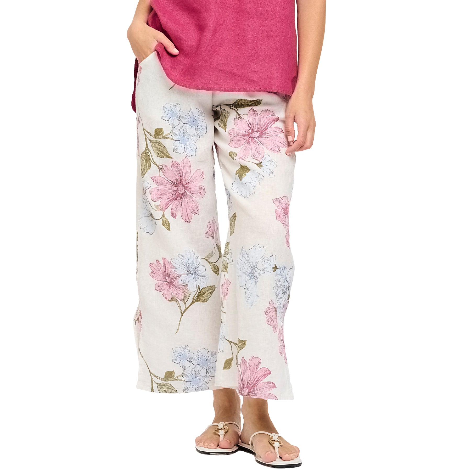Sky pink floral printed linen pants with split leg hem. Front view close up on model.
