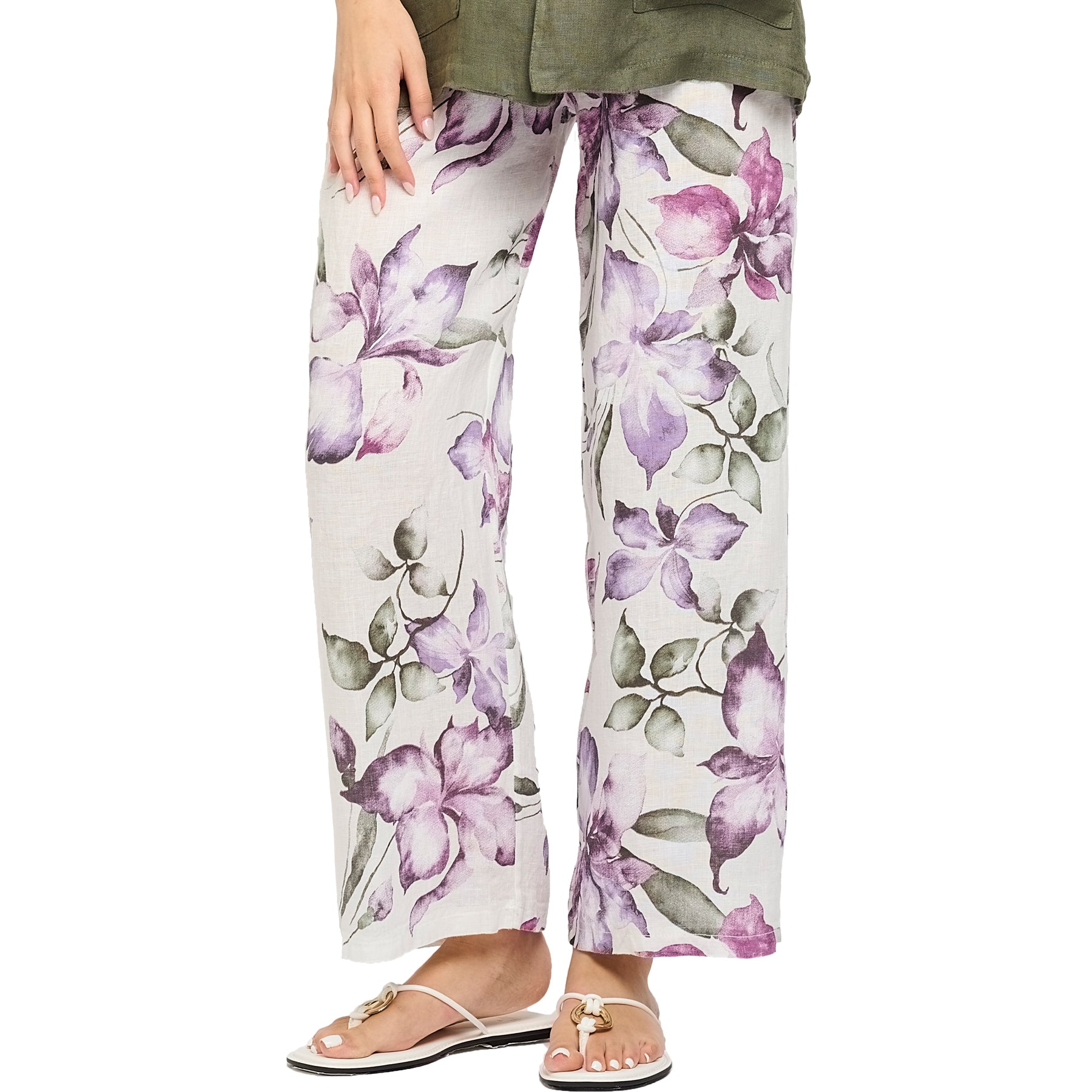 Purple violet/green floral printed linen pants. Front view close up on model.
