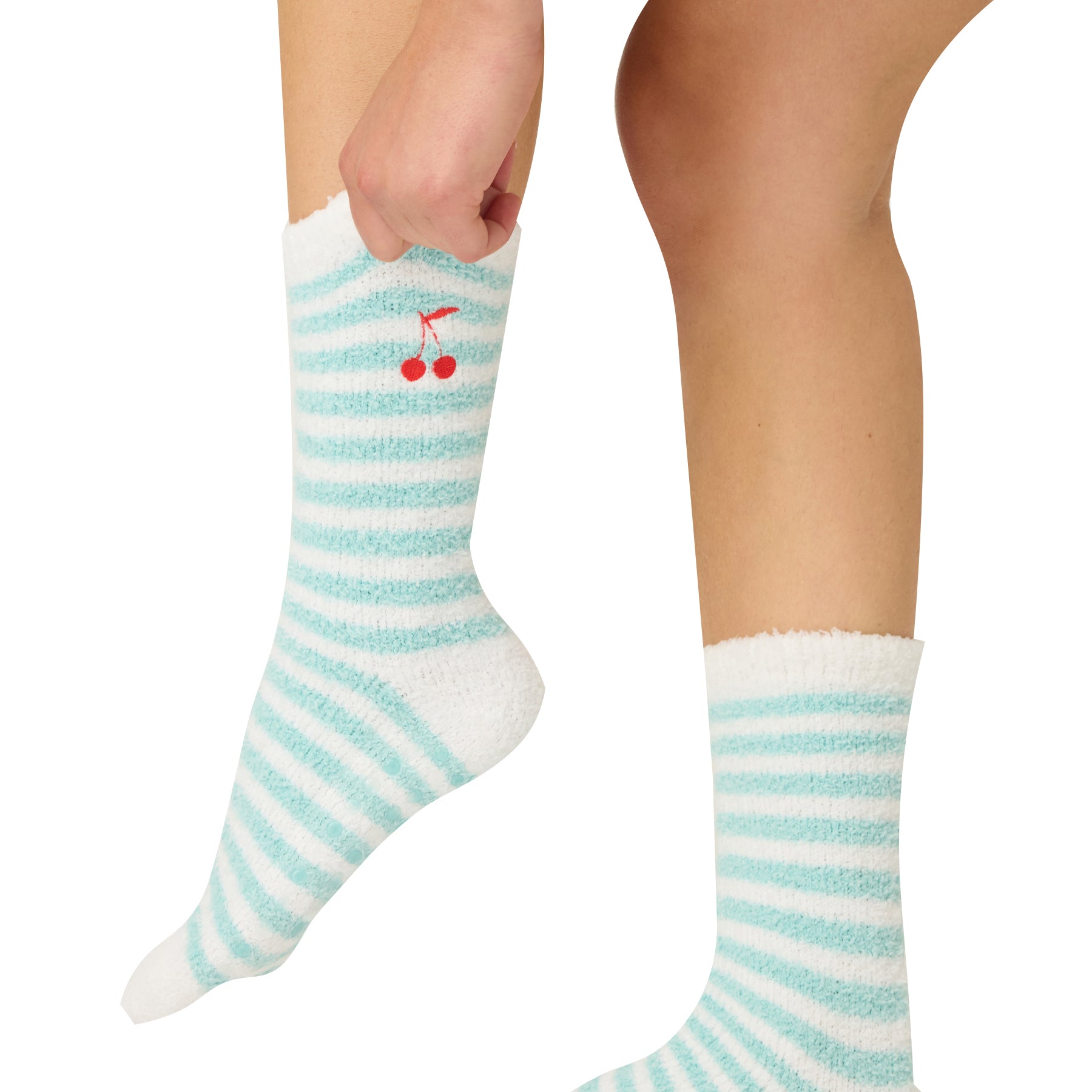 Teal and white striped socks with cherry design worn by a person on a white background