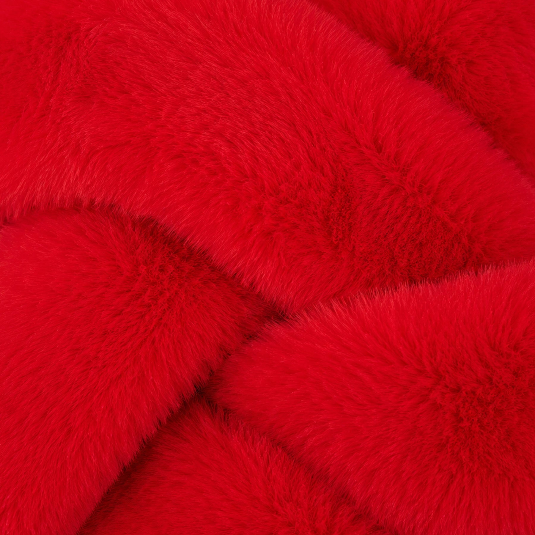 Close-up of bright red plush faux fur fabric showing the soft, fluffy texture of the slippers.