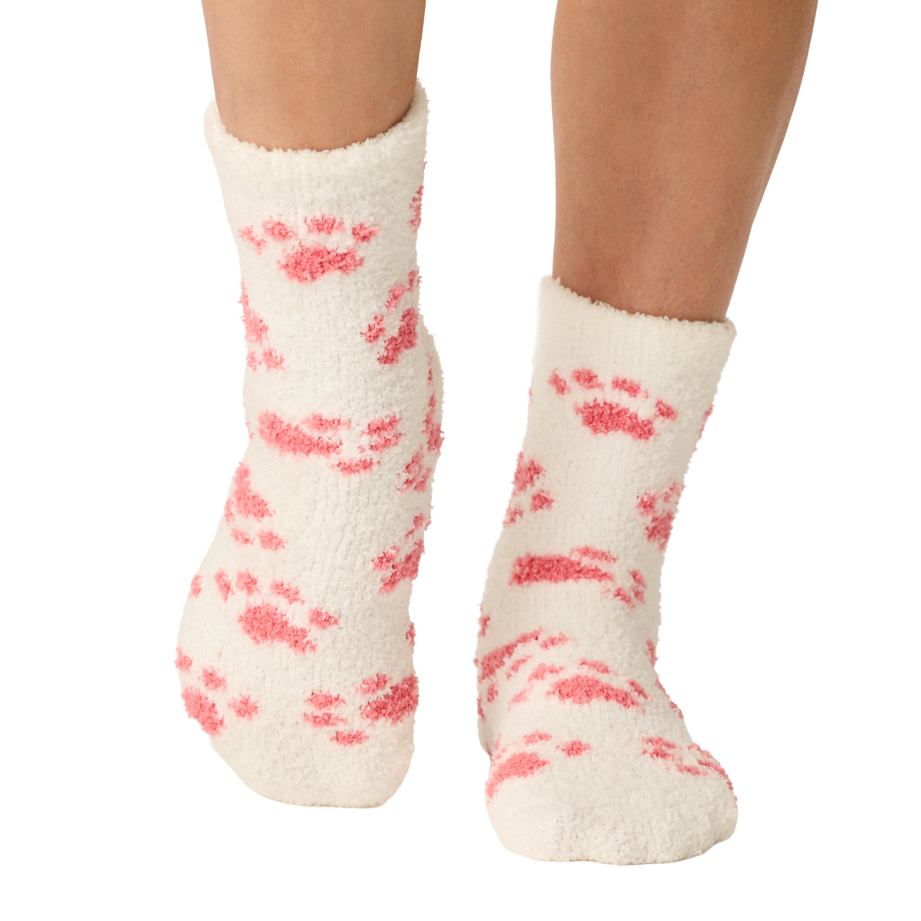 Front view of ivory fuzzy crew socks featuring an all-over pink paw print design.