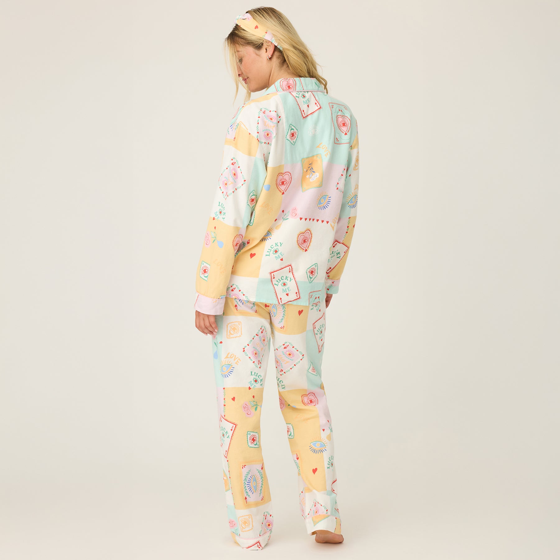 Back view of PJ Salvage RUFLPJ women’s flannel pajamas in natural lucky multicolour patch print