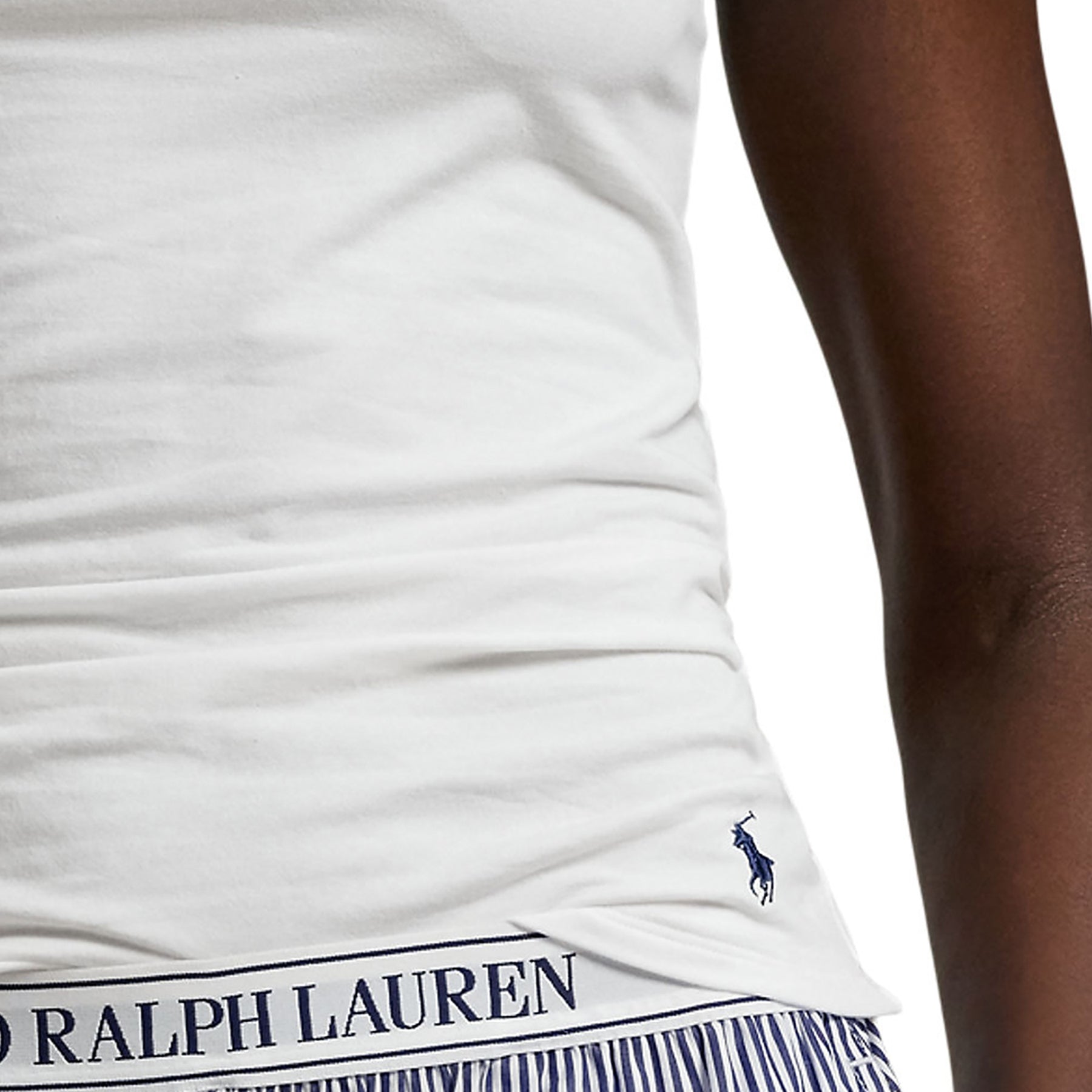 Detailed view of embroidered Polo Ralph Lauren logo and waistband of striped shorts